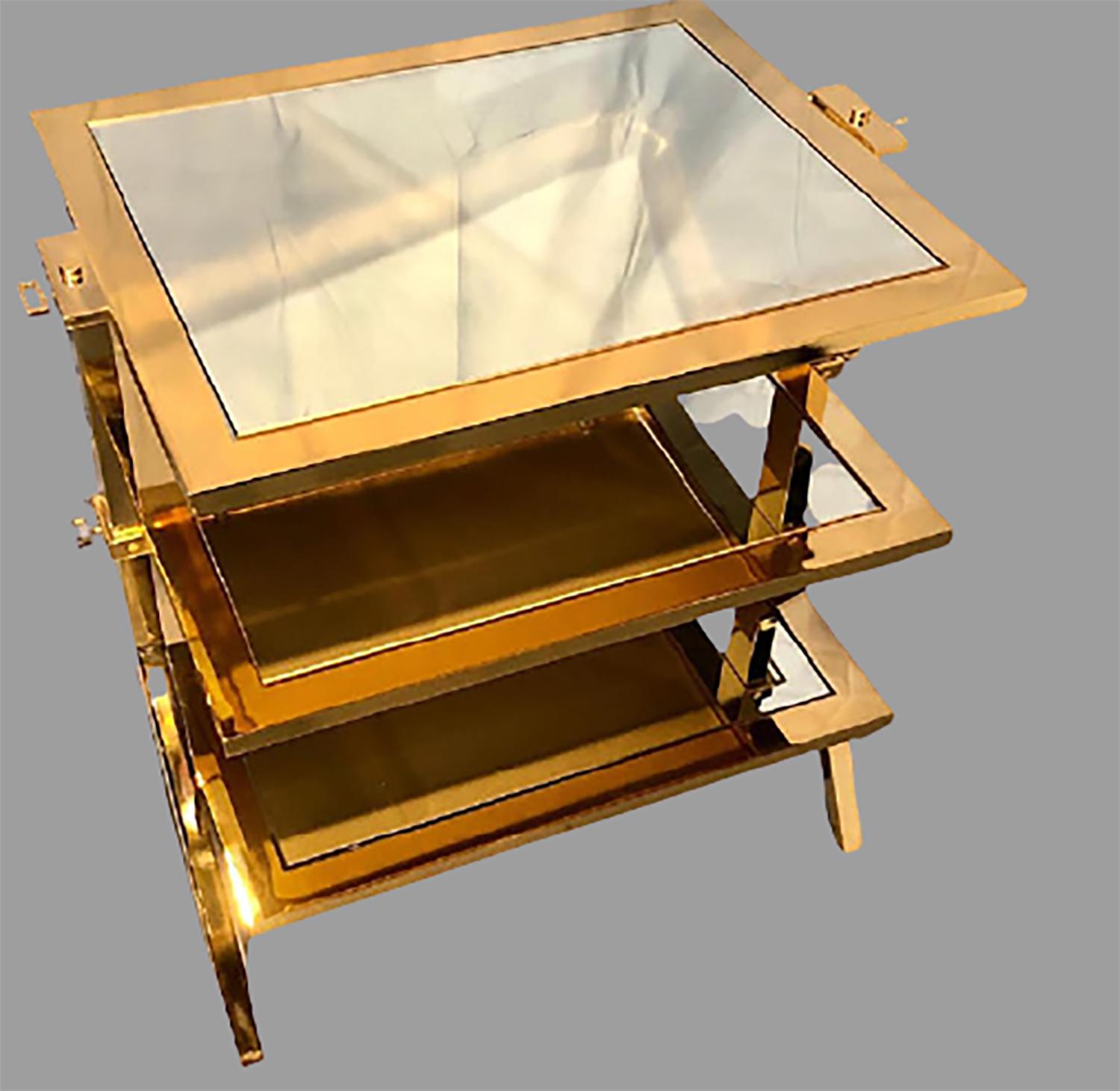Lorin Marsh design three tiered brass and mirrored glass side table. New York, 2000s. Lacquered brass with mirrored glass. Unsigned.

In 1975, Lorin Marsh established their eponymous furniture and decor showroom in the historic New York Decoration