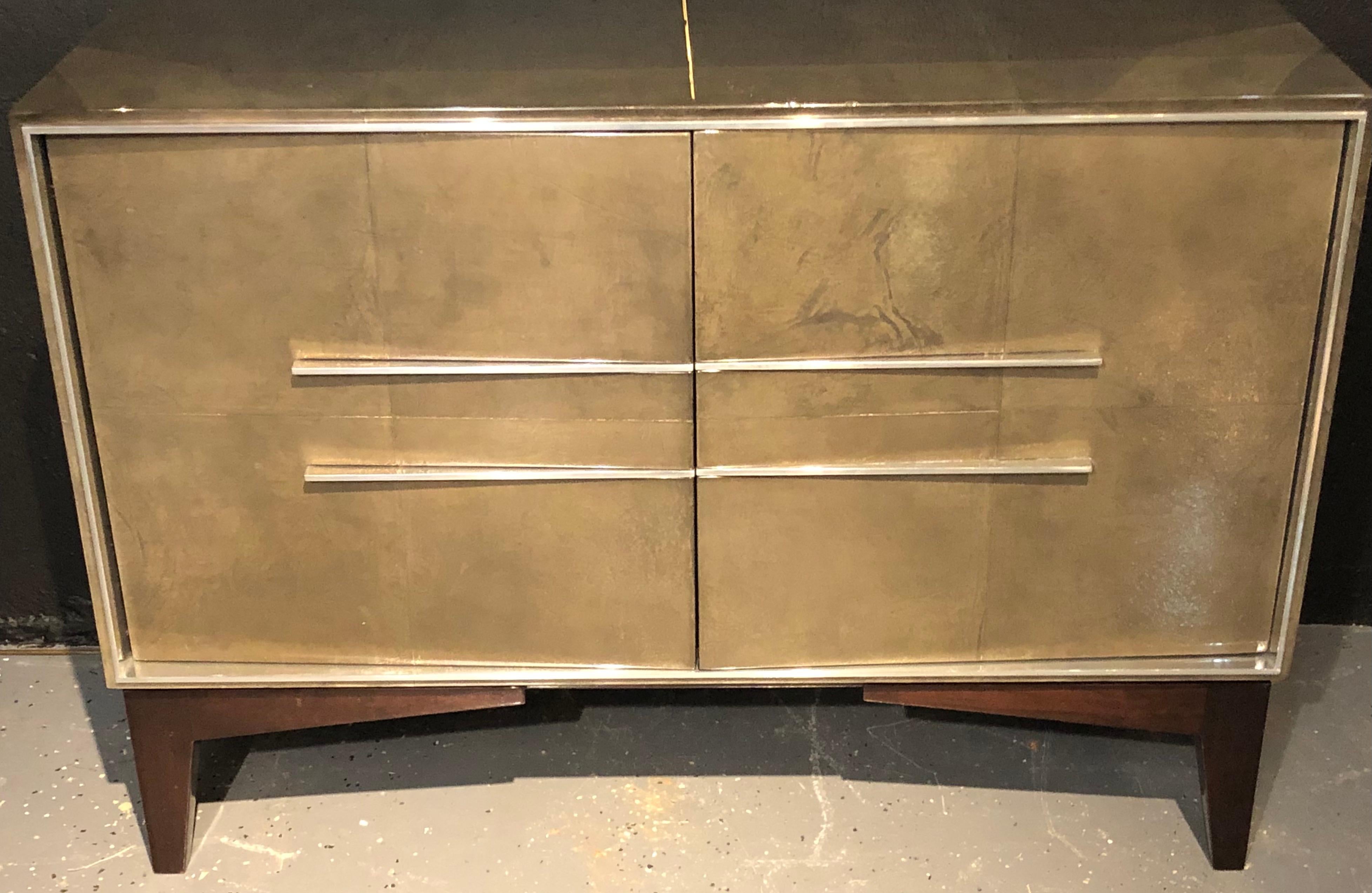 Lorin Marsh Designs Tuxedo two-door cabinet. New York 2000s. Lacquered gunmetal and parchment with Polished steel design. Two doors concealing four interior walnut drawers. Finished back. This chest retails for $18,750 in a lesser Lacquered finish.
