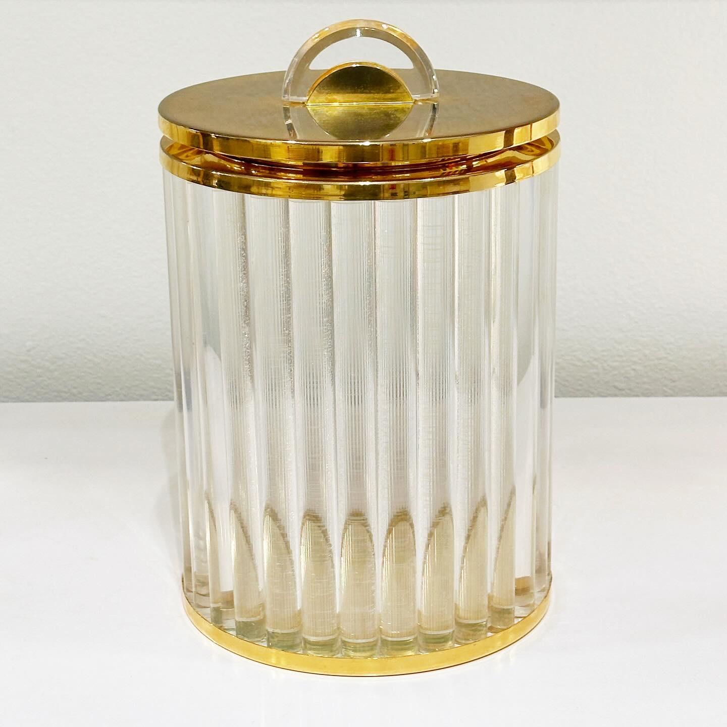 Lorin Marsh fluted lucite ice bucket with gold plated lid and trim, ca 1970s. This is an elegant luxury item retailed at Lorin Marsh, one of the first boutique showrooms in New York. The lid has a Lorin Marsh stamp and the base contains a 