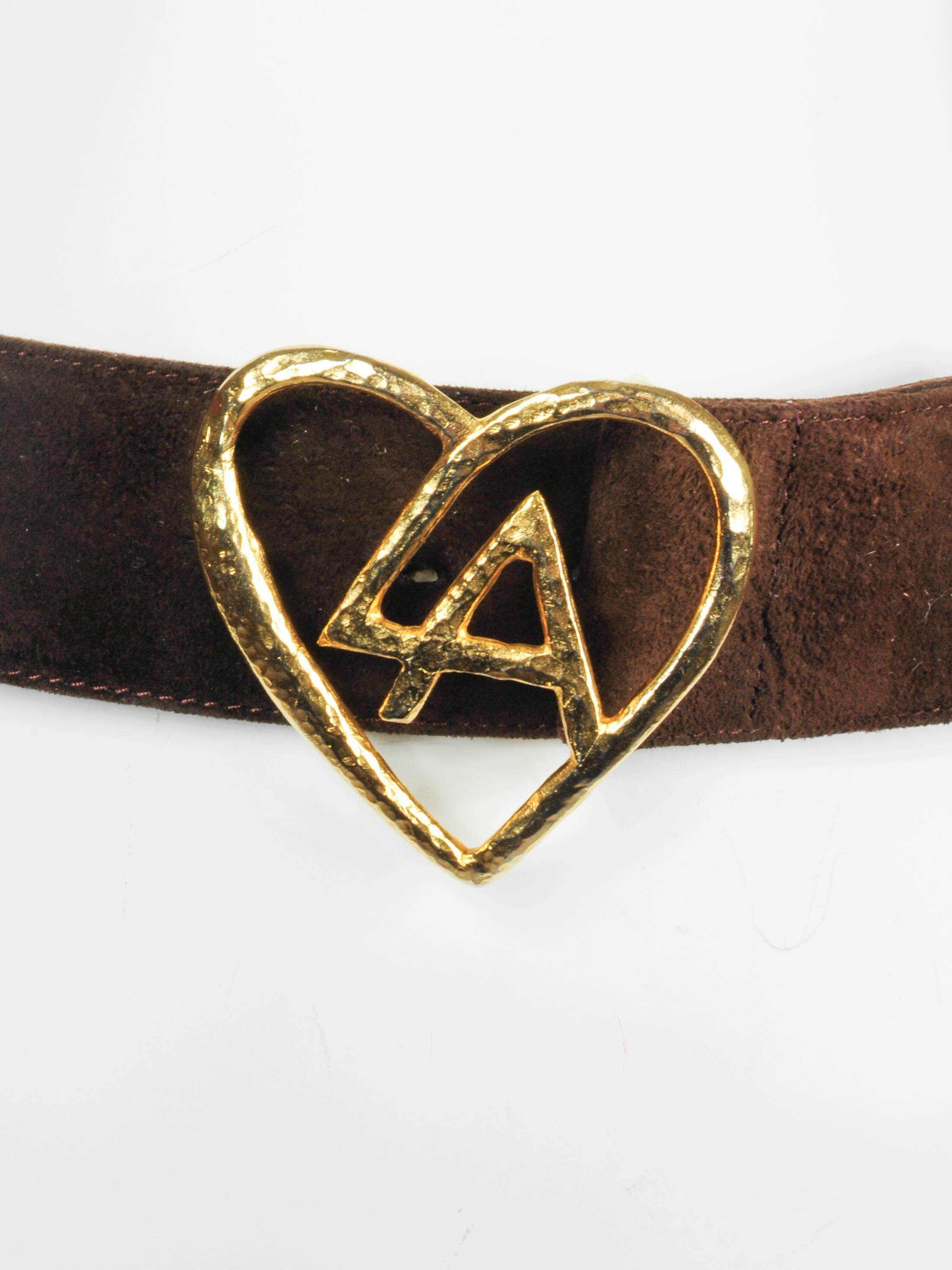 Vintage brown suede Loris Azzaro LA gold heart logo waistbelt from the 1970s. The hammered golden heart with Loris Azzaro’s initials L.A. designed into it. Loris Azzaro is known for this glamourous designs and this definitely fits into that design