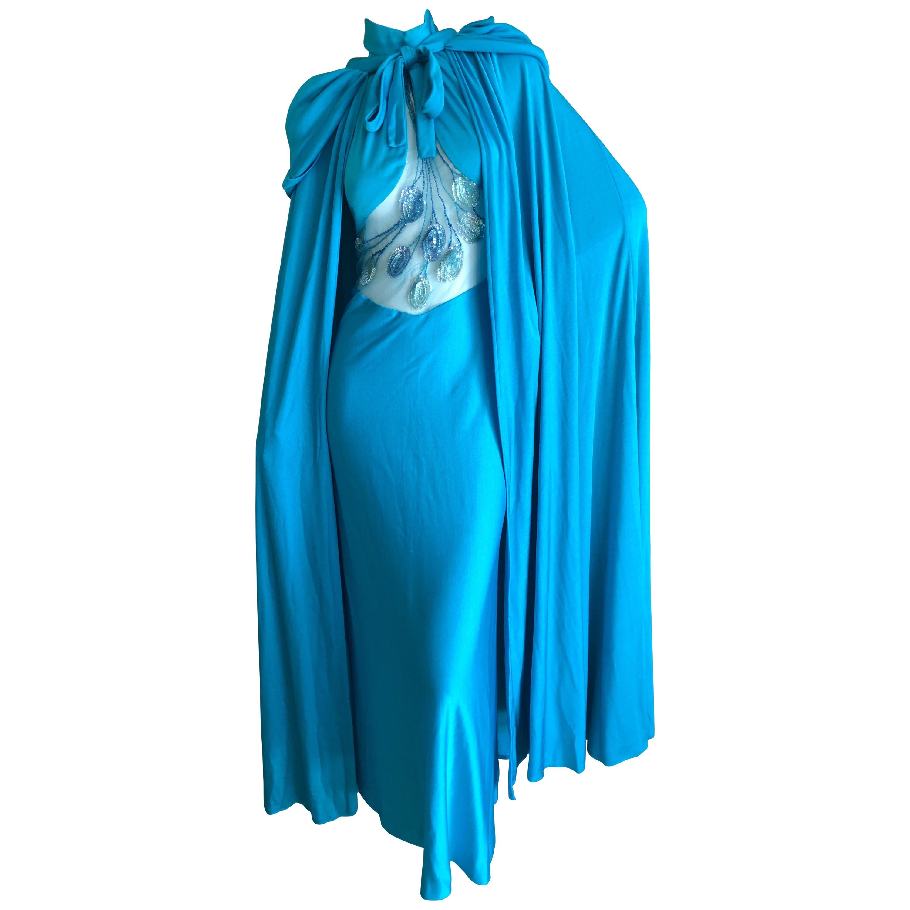 Loris Azzaro Couture 1970s Sheer Sequin Accented Turquoise Blue Dress and Cape.
This is so wonderful, sheer sequin dress with matching hooded cape.
Measured with out stretching 
Bust 34