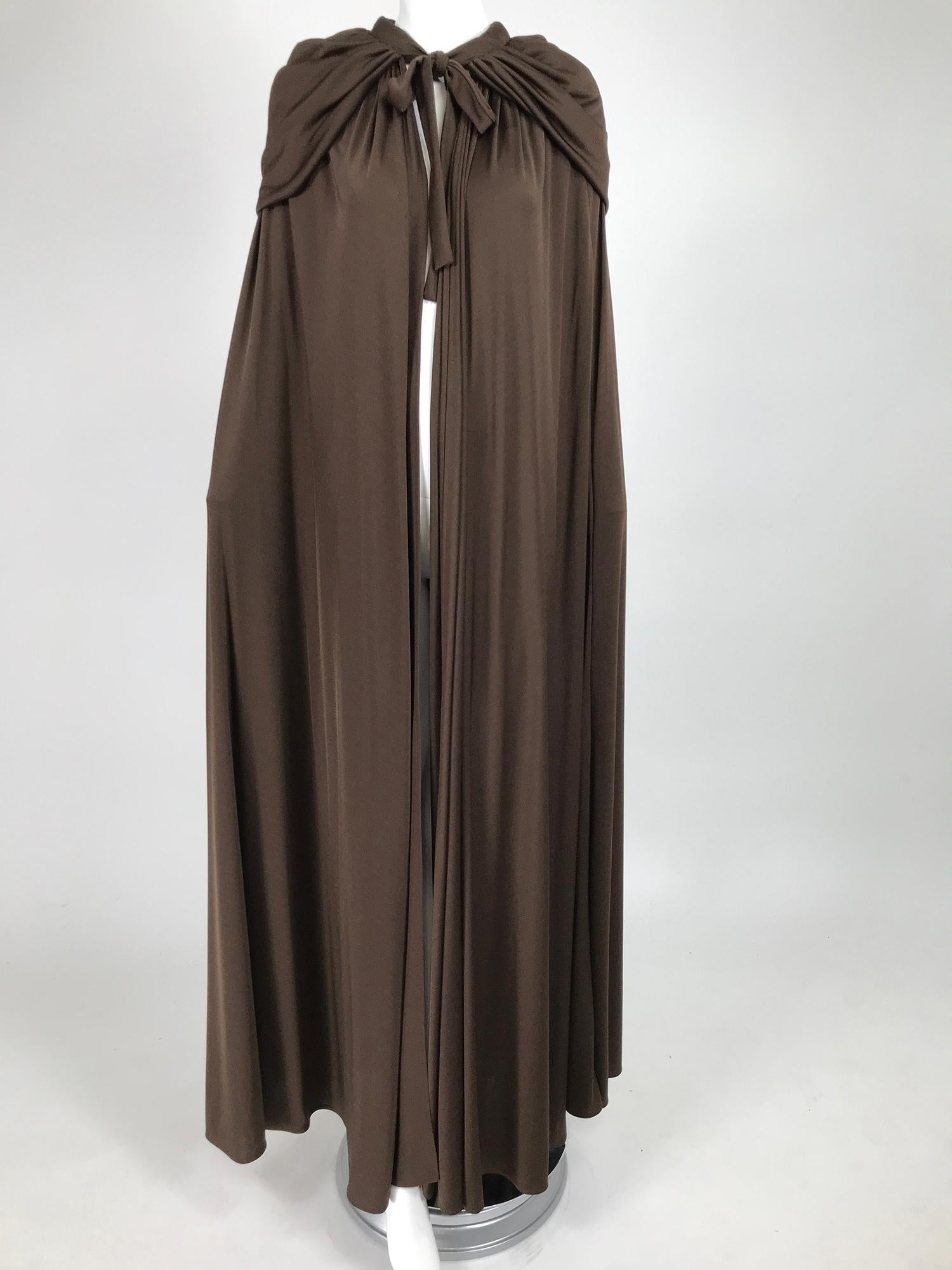 Loris Azzaro Couture chocolate brown silky jersey full length hooded cape from the 1970s. Super model length, this bias cut cape is the perfect addition to any big night. Silky jersey that is very full and dramatic. The cape ties at the neck front,
