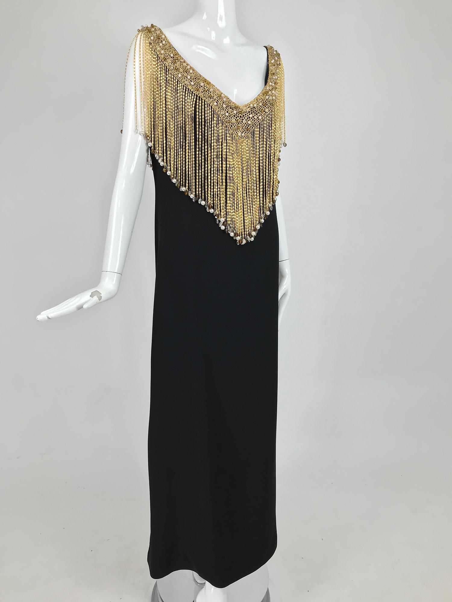 Loris Azzaro Couture gold metal chain fringe, jewel trim collar, black sleeveless maxi dress from the 1970s. One of the most fabulous Azzaro dresses from the 1970s, this black A line sheath is the perfect canvas for the deep cape fringe trim. The