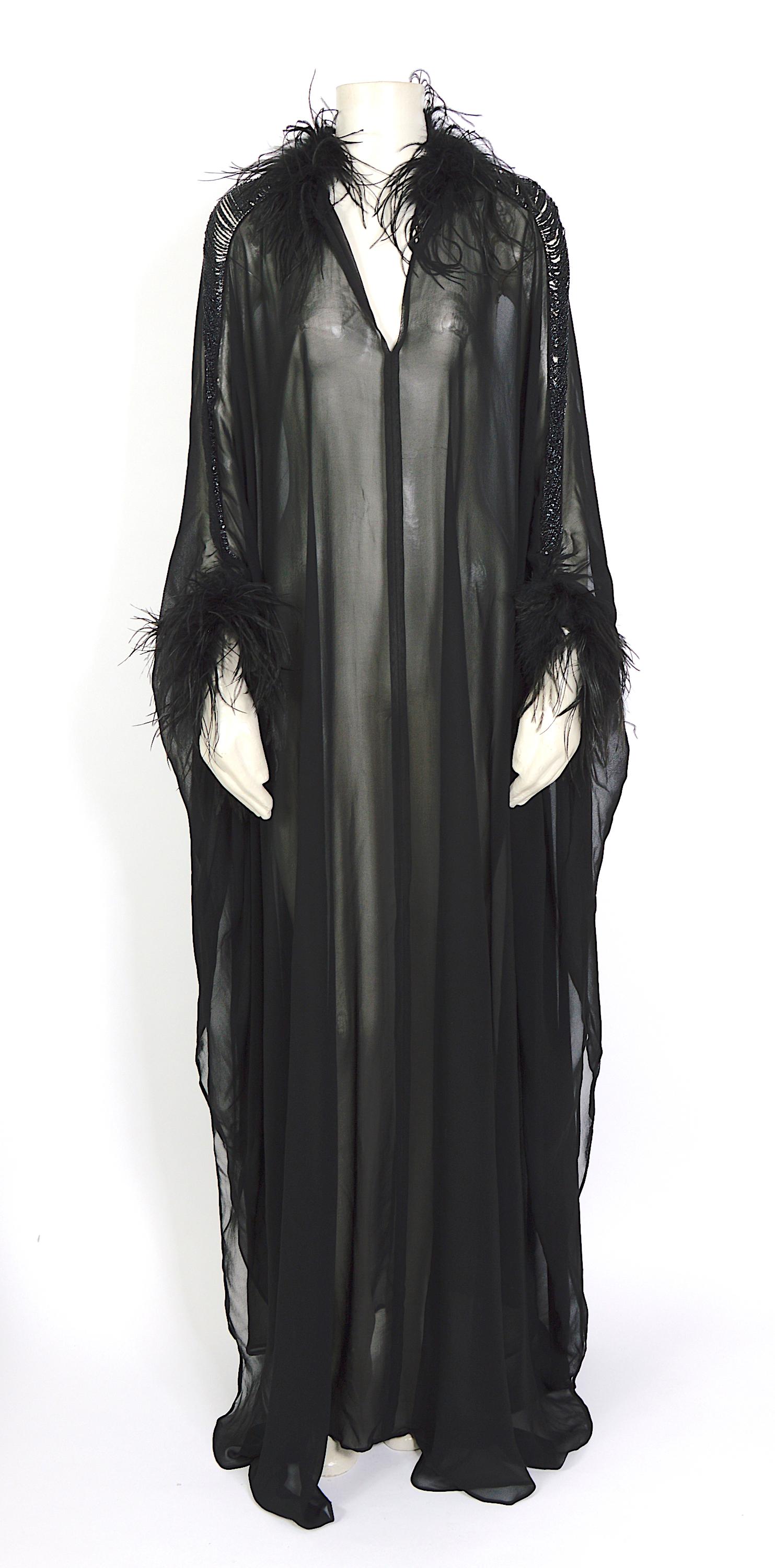 STUNNING!!!
Rare collector vintage 1970s item by Loris Azzaro.
Black silk transparent caftan dress. Sleeve with chain detail, feathers around wrist and neck.
There is no front or back, wear it with or without cleavage.
Excellent condition
Size Free