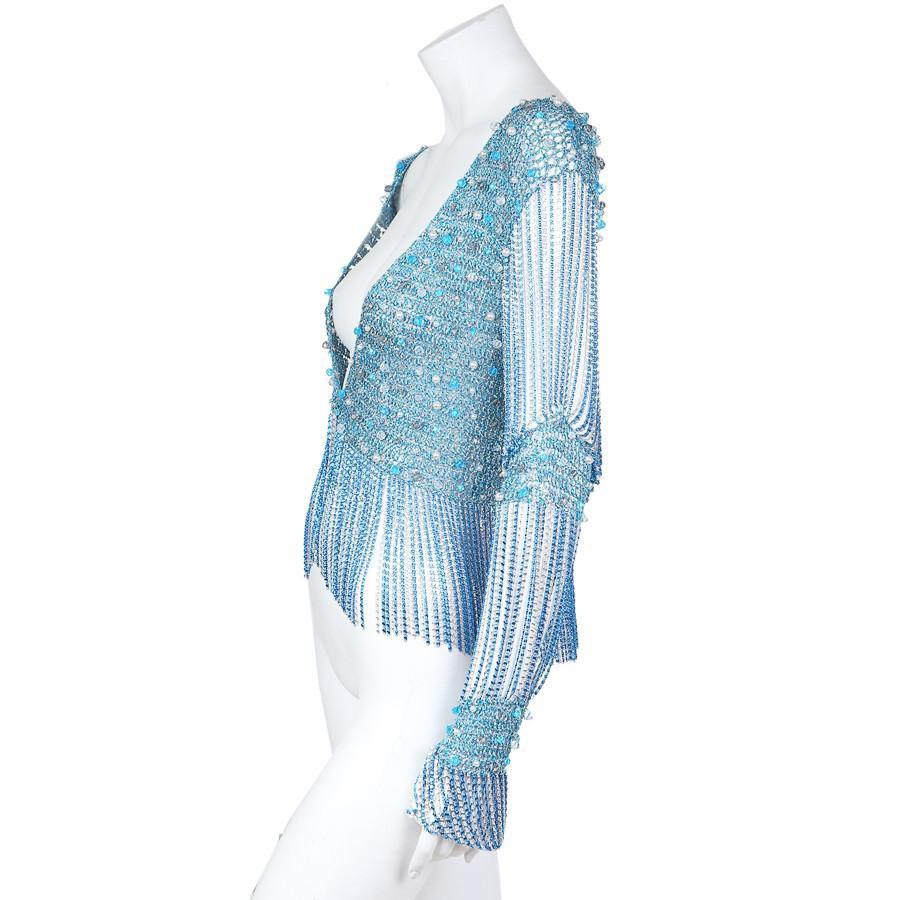A distinct and wonderful example of Loris Azzaro’s contribution to fashion history, this cardigan evokes the flashy European style of knits in the early 1970’s with the use of metallic lurex crochet style knit combined with the modern “s” chainmail