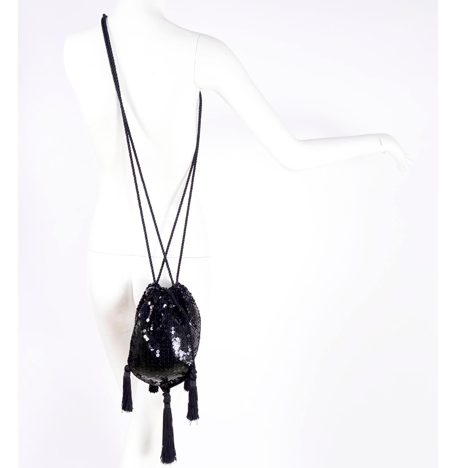 We have always loved vintage Loris Azzaro pieces and this gorgeous evening bag is so incredible! The bag is in black and is covered with black sequins and embellished with luxurious black fringe tassels.   This lovely handbag has a drawstring rope