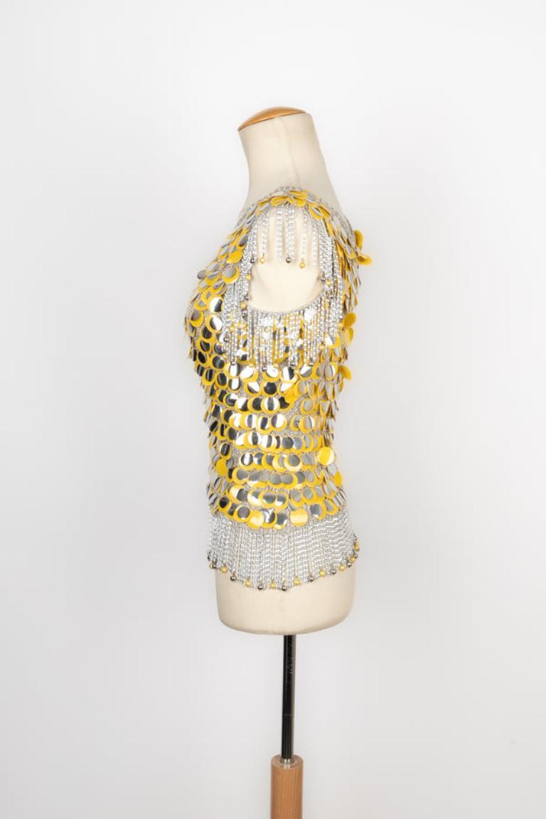 Azzaro - (Made in France) Long silvery mesh top with silvery and yellow pastilles. No brand nor composition label, it fits a 36FR. Piece from the 1970s.

Additional information: 
Condition: Very good condition
Dimensions: Chest: 38 cm - Length: 62