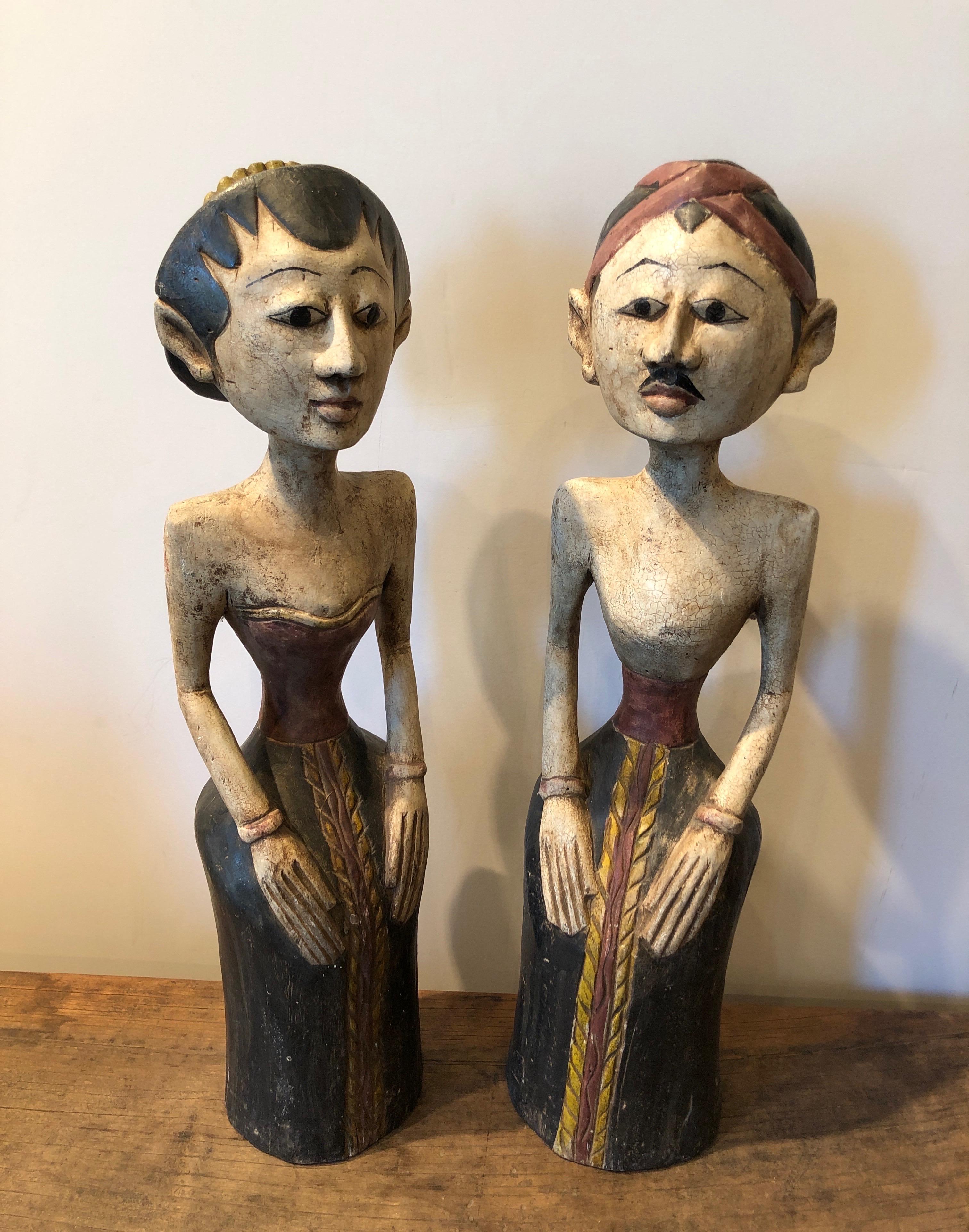 A pair of expertly hand carved, mid-century Loro Blonyo figures representing the inseparable couple. This graceful wedding couple is dressed as bride and groom. They are thought to bring fertility and prosperity. They will certainly bring beauty,