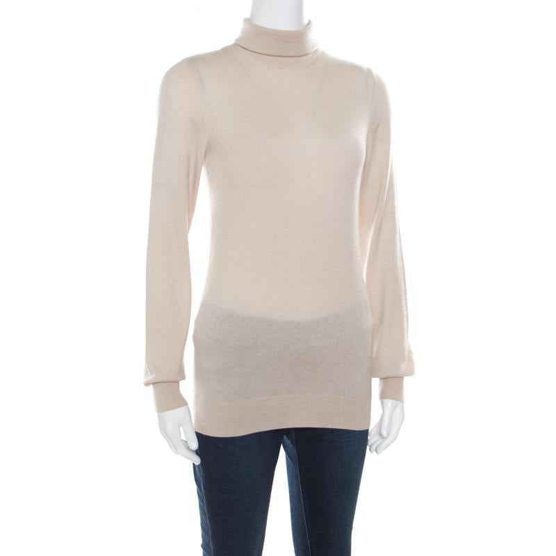You'll love to wear this Loro Piana sweater whenever you step out on a chilly day as it delights in a beige shade. The sweater is made of cashmere and features a simple design of long sleeves and a turtle neck.

Includes: The Luxury Closet