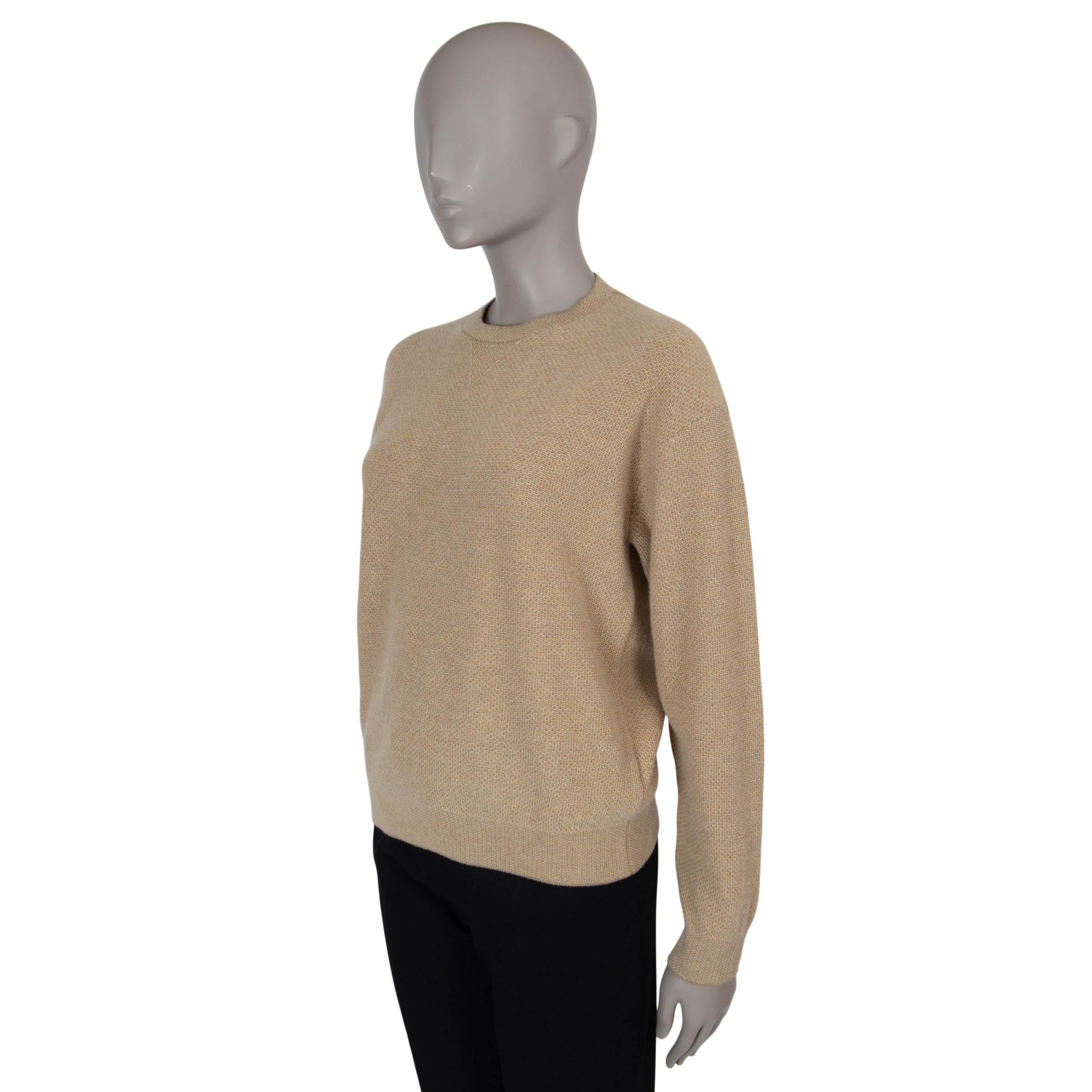 This 100% authentic Loro Piana track sweatshirt in beige honeycomb knit cashmere (100%) combines relaxed elegance with unparalleled comfort. Designed with a loose silhouette, dropped shoulders, and rib-knit trims, it’s perfect for laid-back luxury.