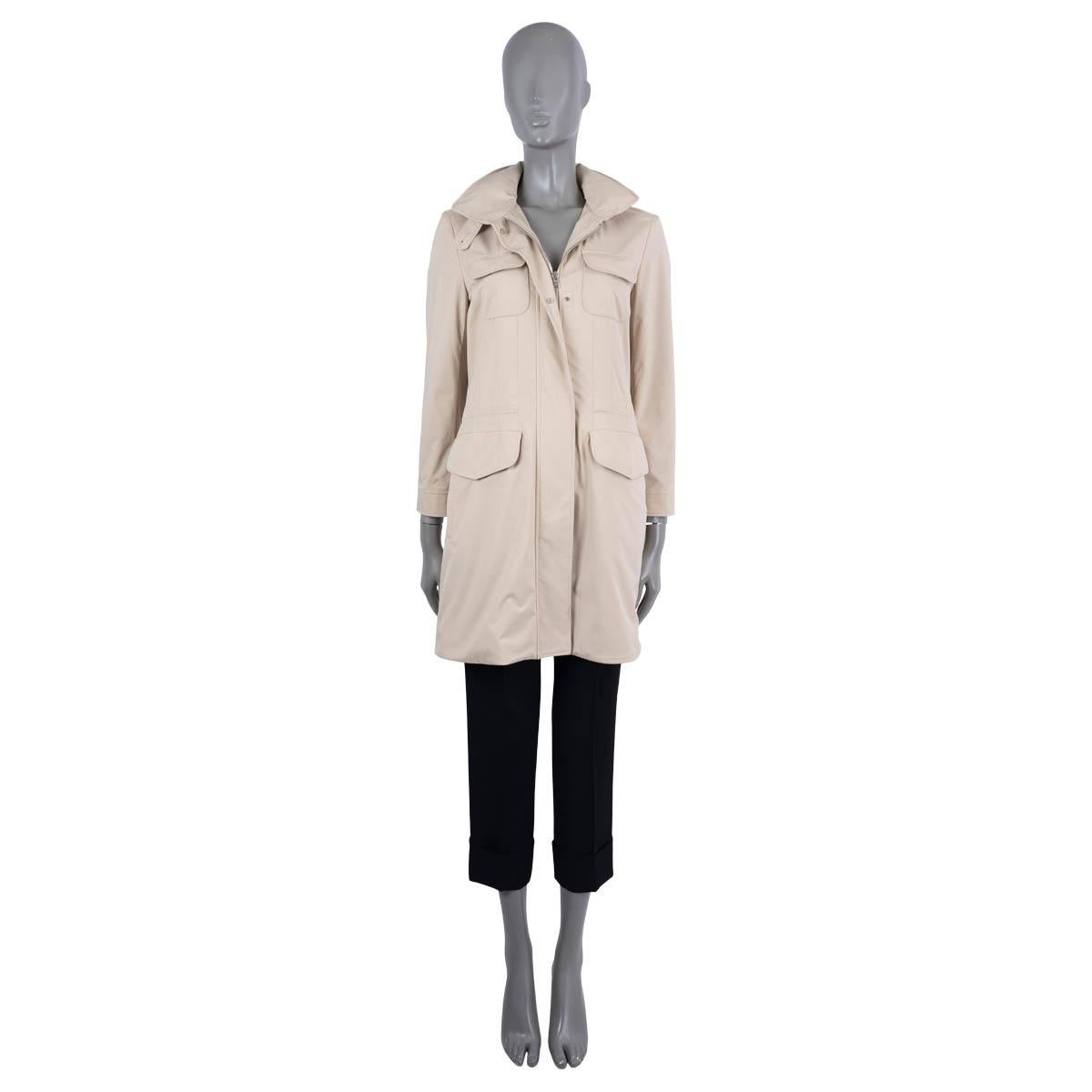 100% authentic Loro Piana traveller jacket in beige Windmate® Stretch nylon (100%).  Features Storm System® treatment making it waterproof and wind-resistant, four flap pockets on the front, a high collar with fold-away hood, a drawstring waist and
