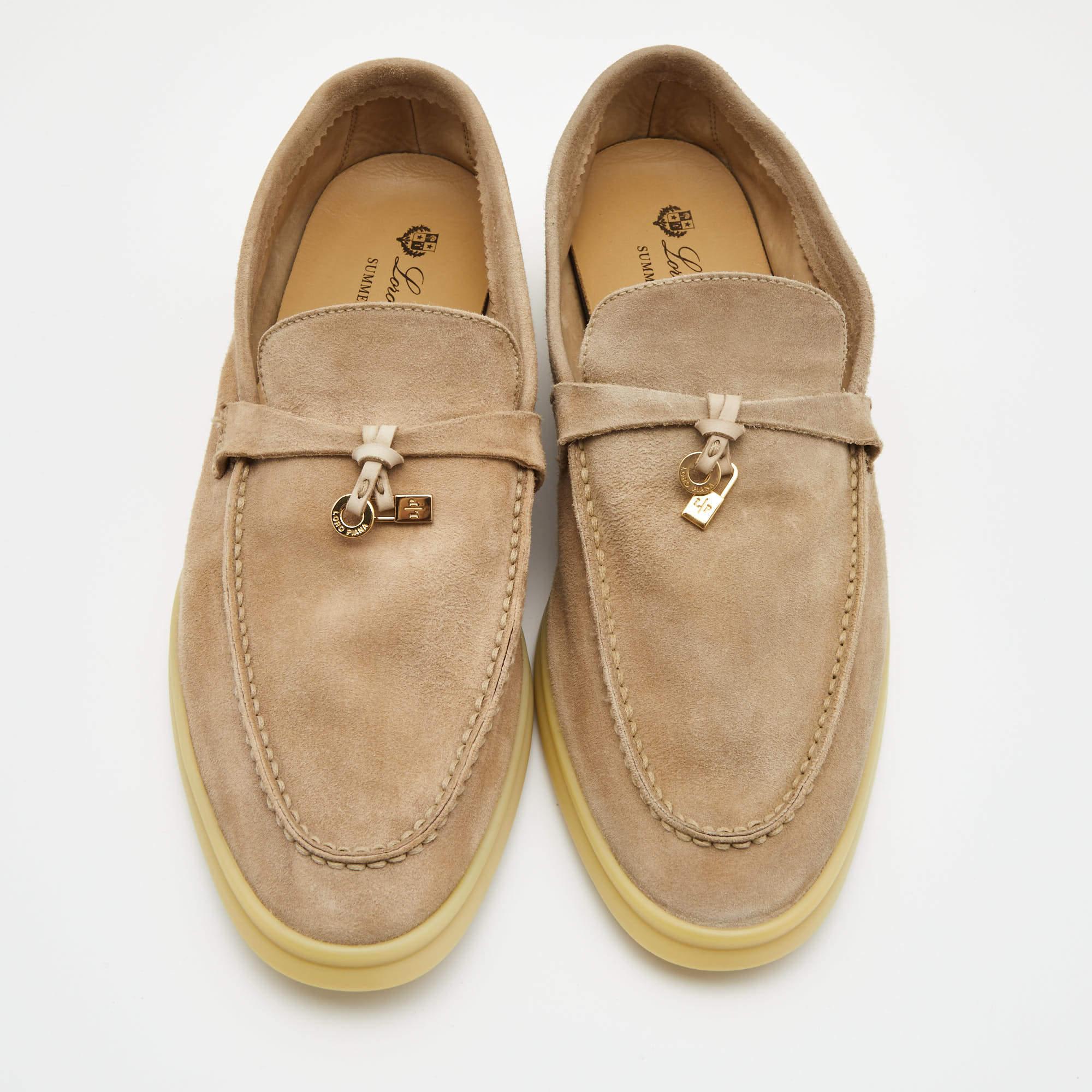 These sophisticated Summer Walk loafers from Loro Piana are crafted from suede and feature a neat design with sleek cuts. They flaunt round toes, signature charms, a beige hue, comfortable leather-lined insoles, and durable rubber