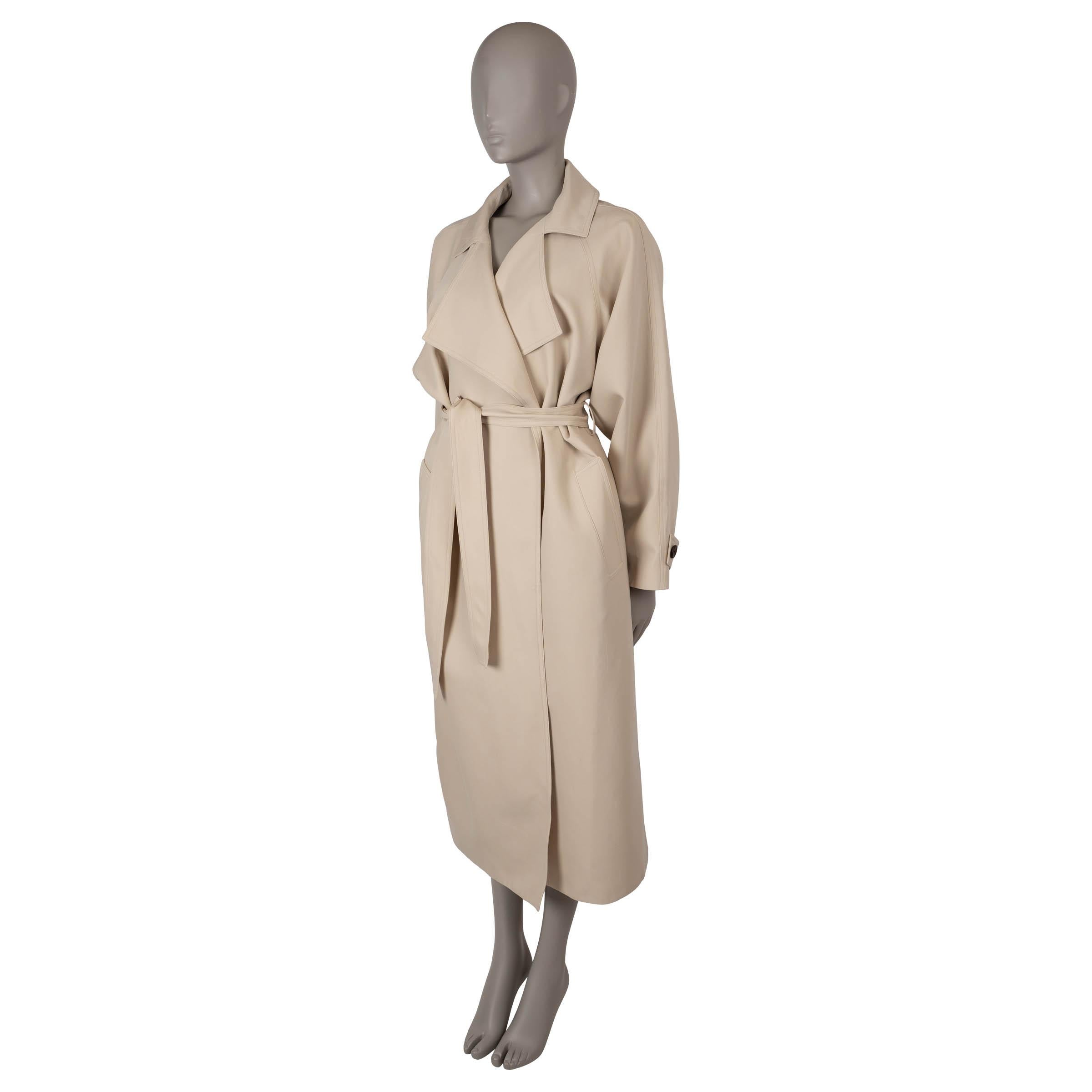 This 100% authentic Loro Piana Bille trench coat in Soya Bean beige is crafted from a luxurious blend of wool (90%) and silk (10%). It features a relaxed silhouette with a midi length, raglan sleeves (measured from the neck), buttoned belts at the