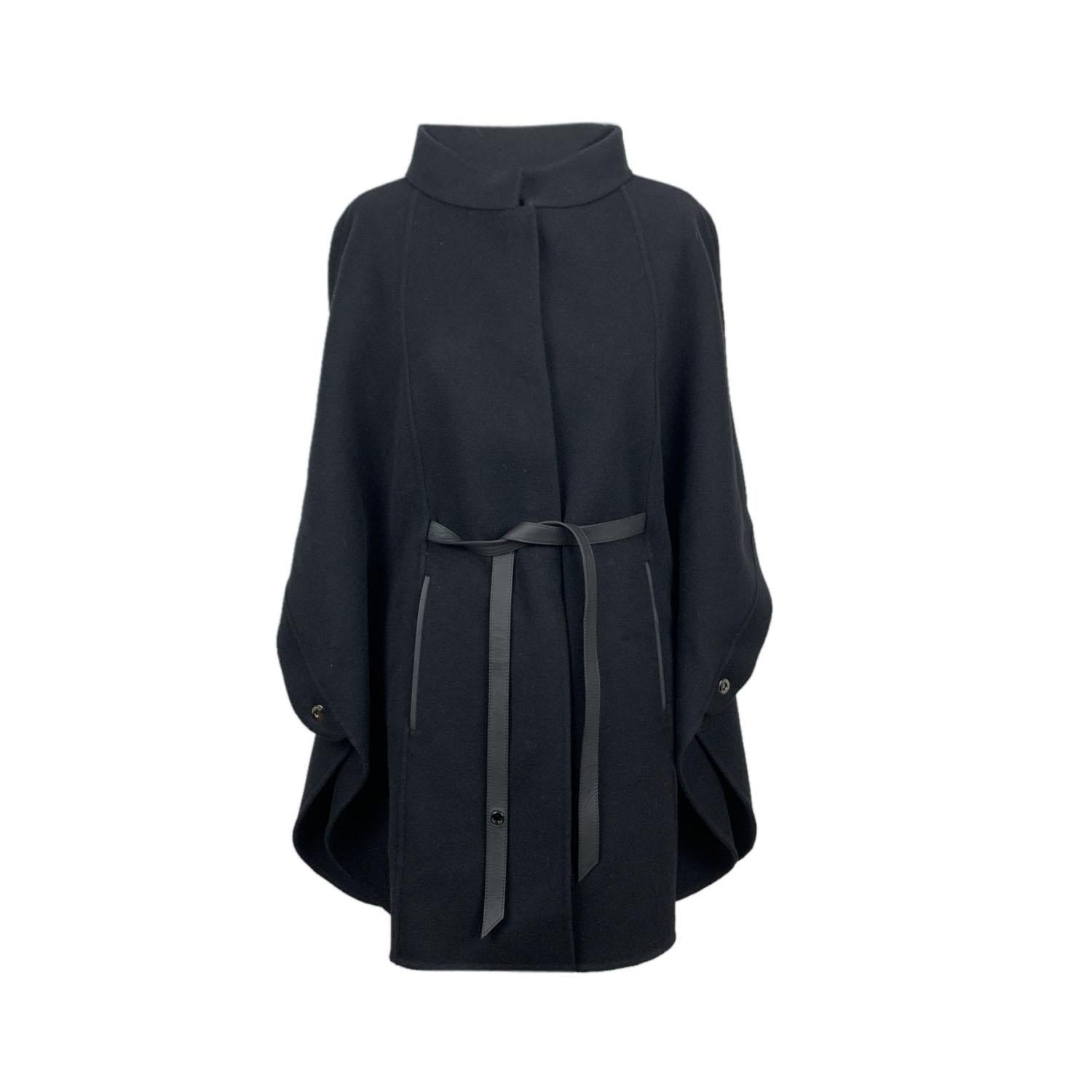 Beautiful Loro Piana 'Salzburg' Cape in black color. Crafted in 100% cashmere. Concealed button closure on the front. Relaxed fit. Button closure on the front. Black leather belt. Side pockets. Unlined. Size: One size. Made in