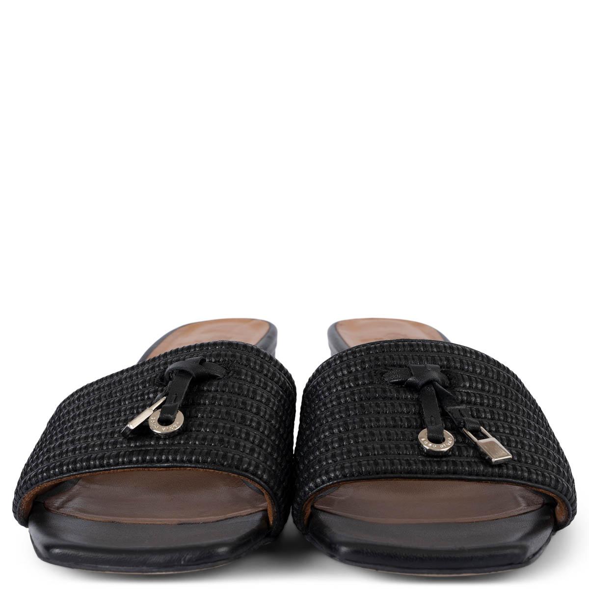 100% authentic Loro Piana Summer Walk mules in black leather and raffia. The slip-on style is accessorized with silver-toned logo-engraved charms and sits atop chunky block heels. Have been worn and are in excellent condition.