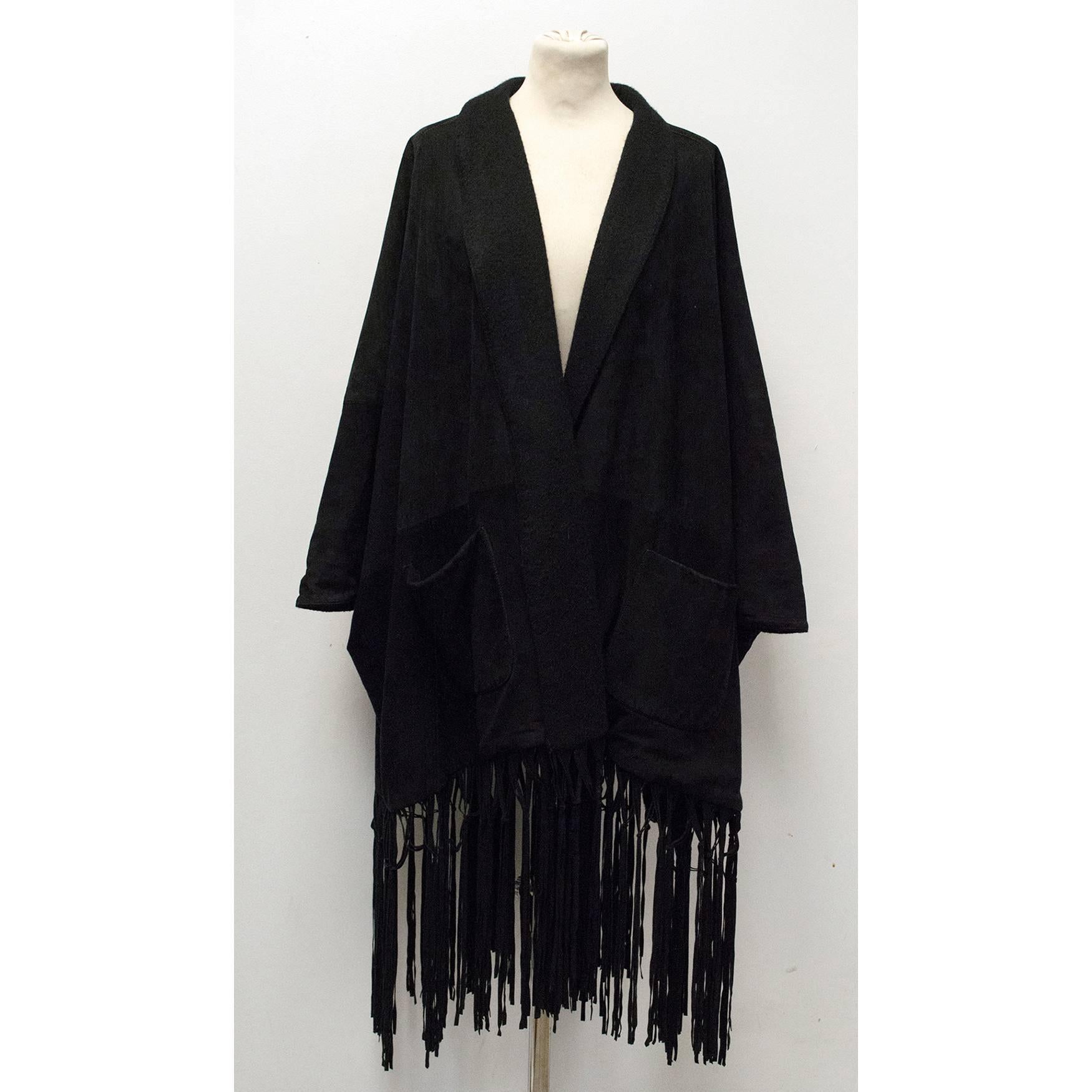 Loro Piana black suede coat with a cashmere shawl lapel, fringed hem and a cashmere lining. The coat is very soft to the touch and medium weight with a relaxed oversize fit and two large pockets on the front. Made in Italy. 

100% Suede with a 100%