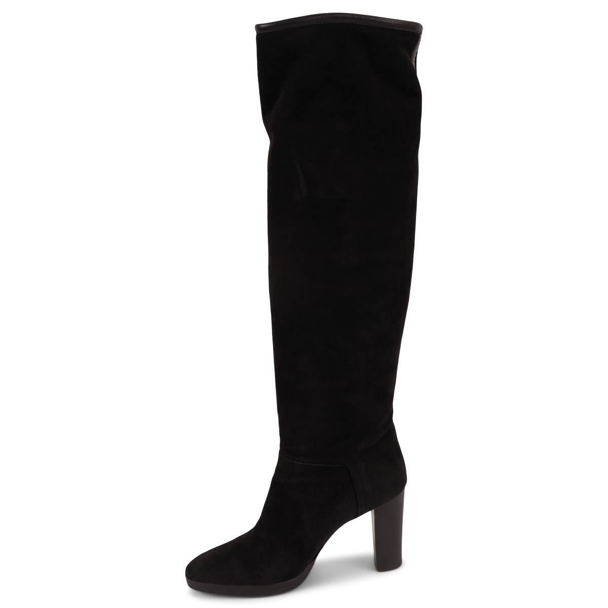 100% authentic Loro Piana Thador knee high boots in black suede with black leather trim. The design features a stacked heel and platform. Lined in black cashmere. Have been worn and shows soft wear to the suede, the heels and the sole. Overall in