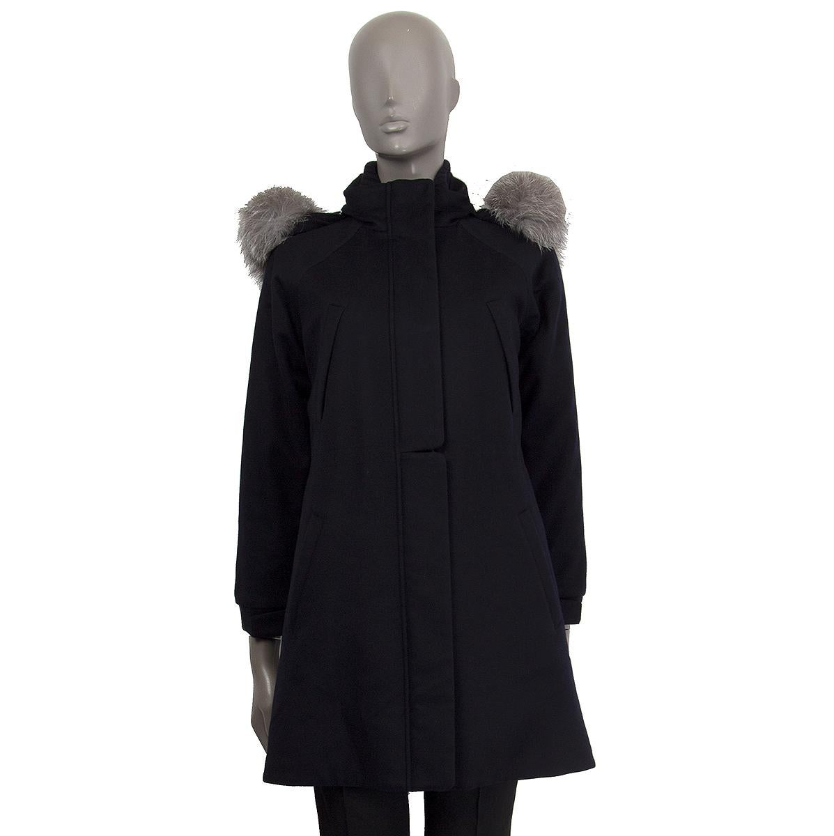 Loro Piana iconic 'Icery Long' coat in midnight blue cashmere (100%) with removable hood with dyed blue fox fur trim. Raglan sleeves have been measured fron neck. Two front zipper and open pockets. Opens with hidden zipper and buttons on the front.