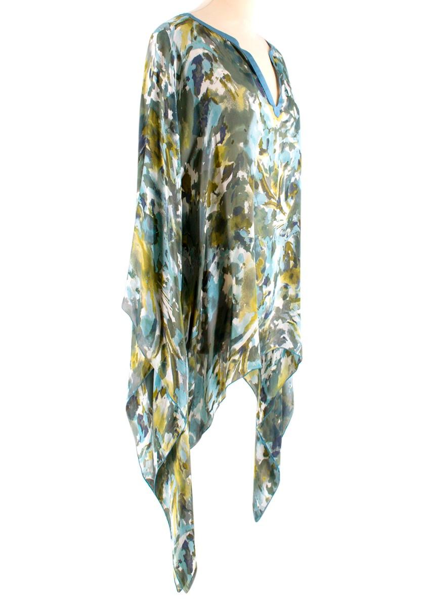 Loro Piana Blue Green Floral Blouse 
- V neckline
- Blue Silk trim
- Blue green and lime floral print
- Cape shape blouse
- Batwing sleeves
- Flowing longer silk down the left and right side

Material 
100% Silk

Dry Clean Only

Made in Italy