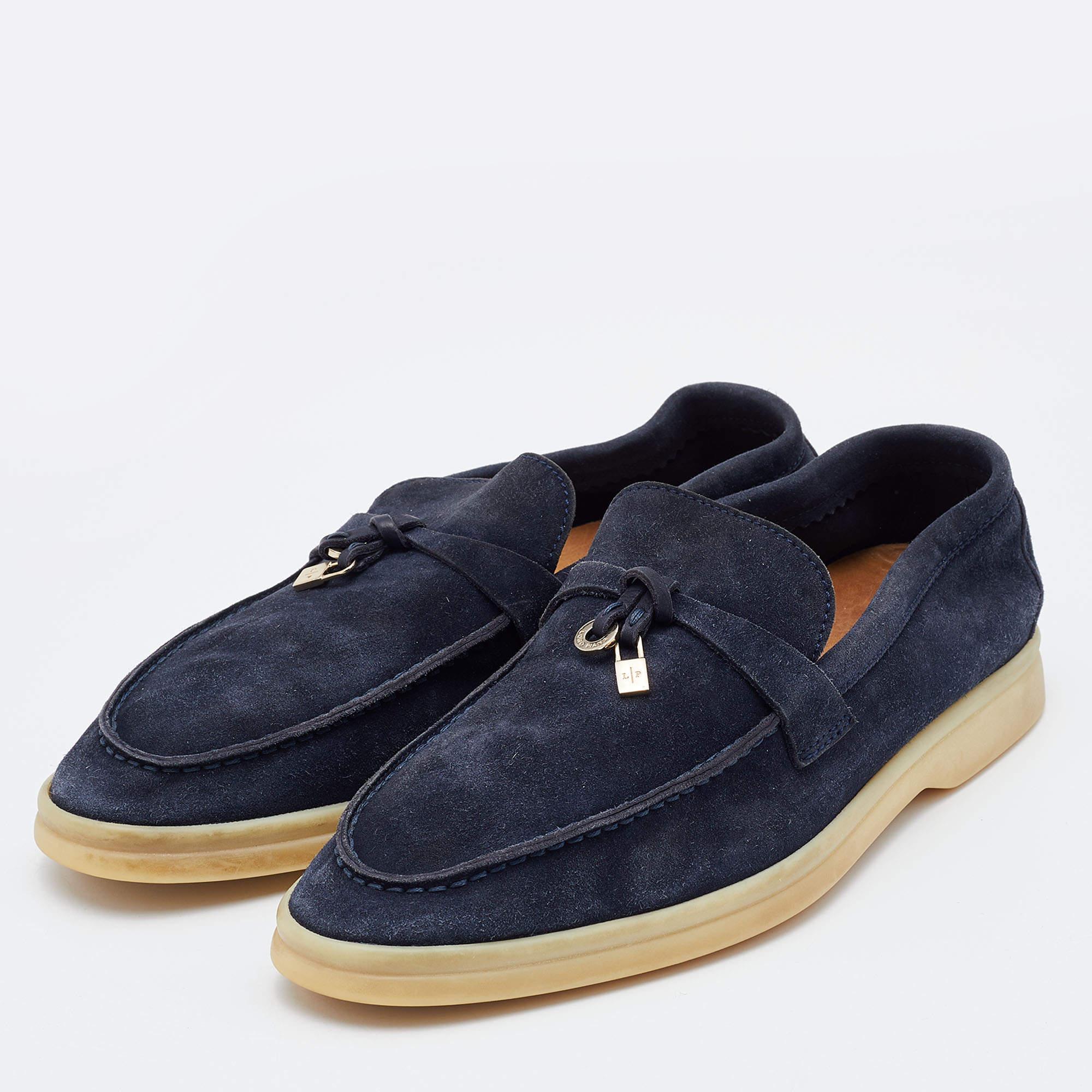These blue loafers from Loro Piana are crafted from suede into a neat design. They flaunt round toes, silver-tone charms on the vamps, comfortably lined insoles, and durable rubber soles.

