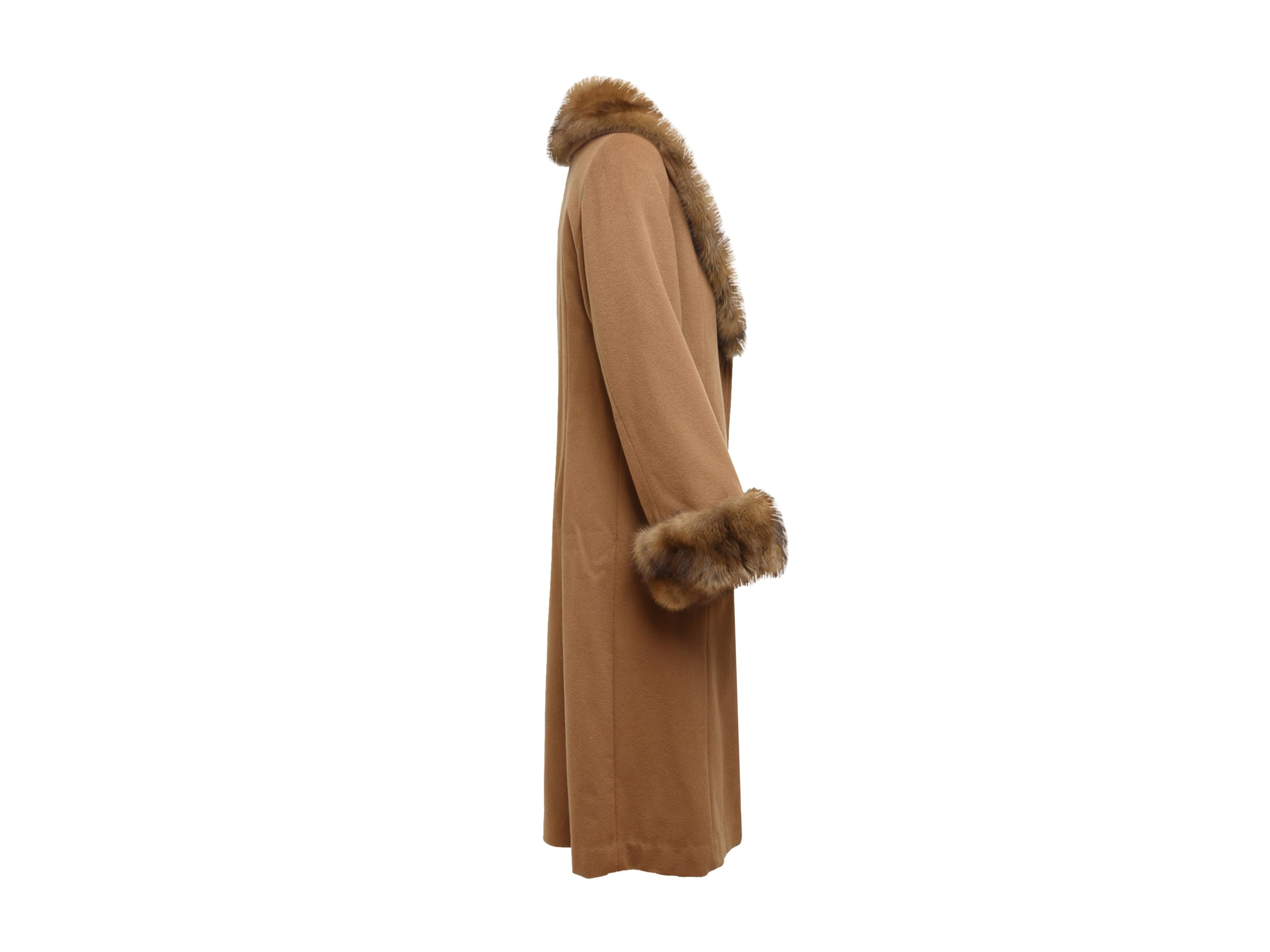 Product details: Brown custom cashmere winter coat made with authentic Loro Piana material. Sable fur trim throughout. Long sleeves. Dual pockets at hips. Button closures at center front. 36