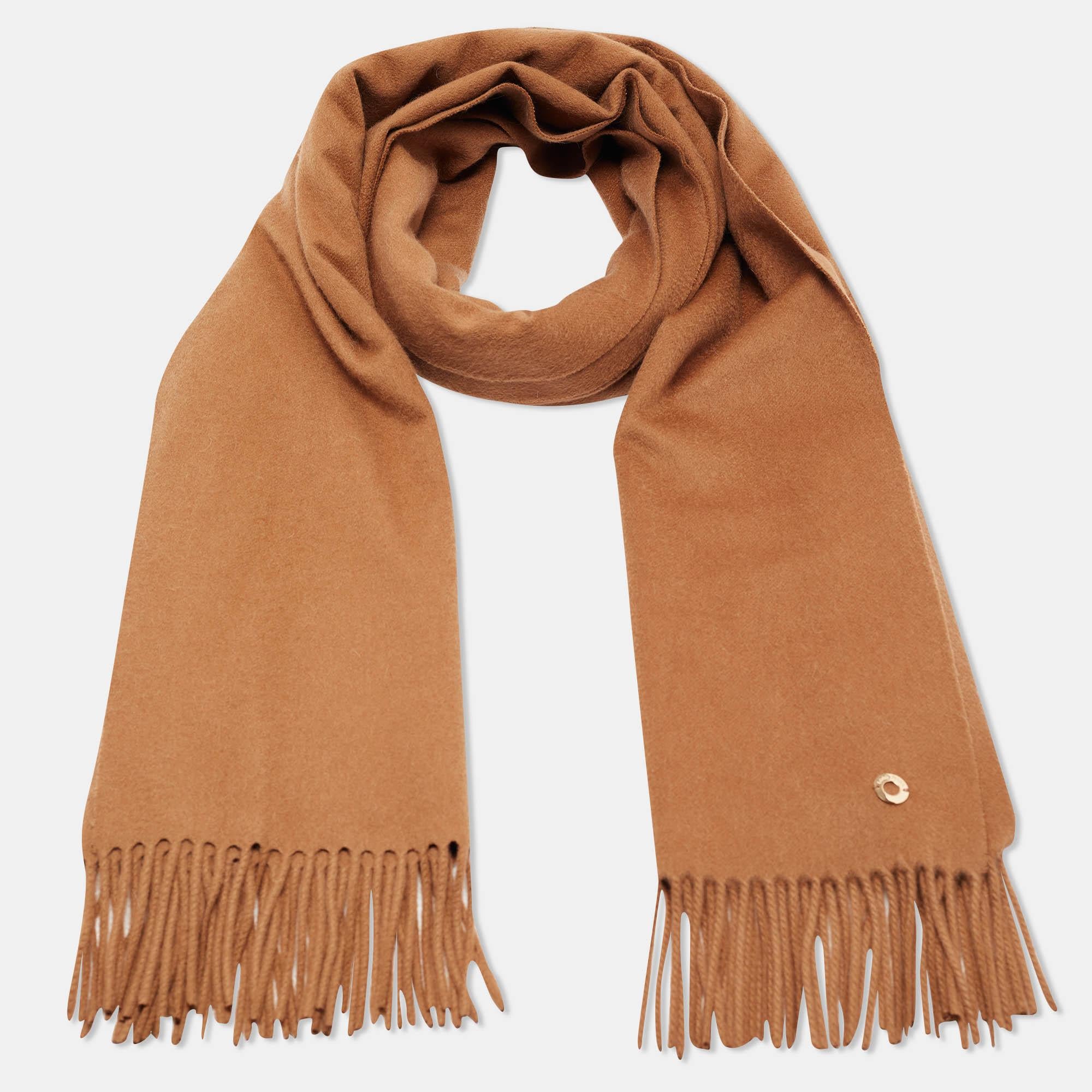 Crafted from the rare and exquisite Vicuña wool, the Loro Piana stole exudes unparalleled luxury. Its rich brown hue adds warmth and sophistication to any ensemble. Delicately woven with precision, it drapes effortlessly, enveloping the wearer in