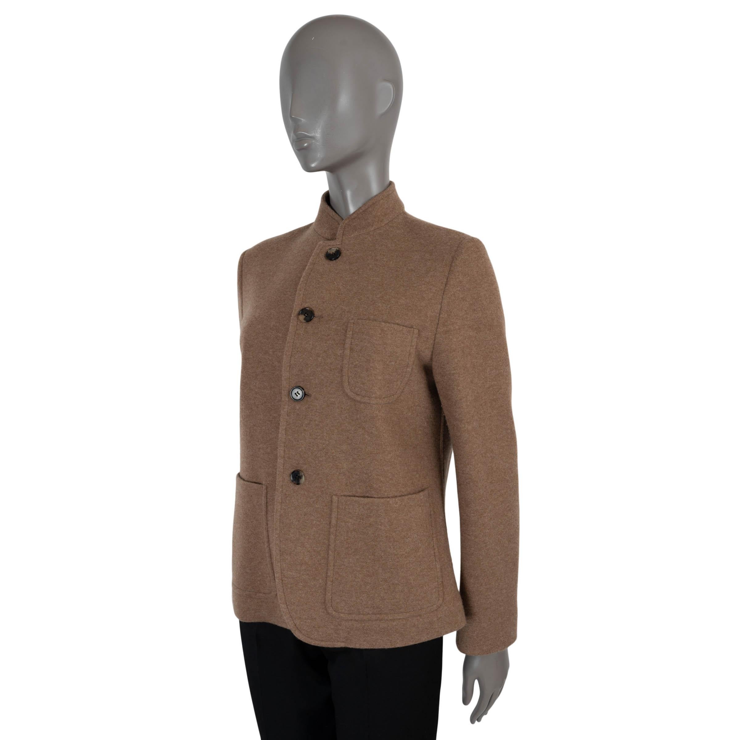 This 100% authentic Loro Piana Spagna jacket in lightweight caramel cafe cashmere (94%) and nylon (6%) offers a refined blend of luxury and practicality. The design features an upright banded collar, four horn buttons, and three large patch pockets