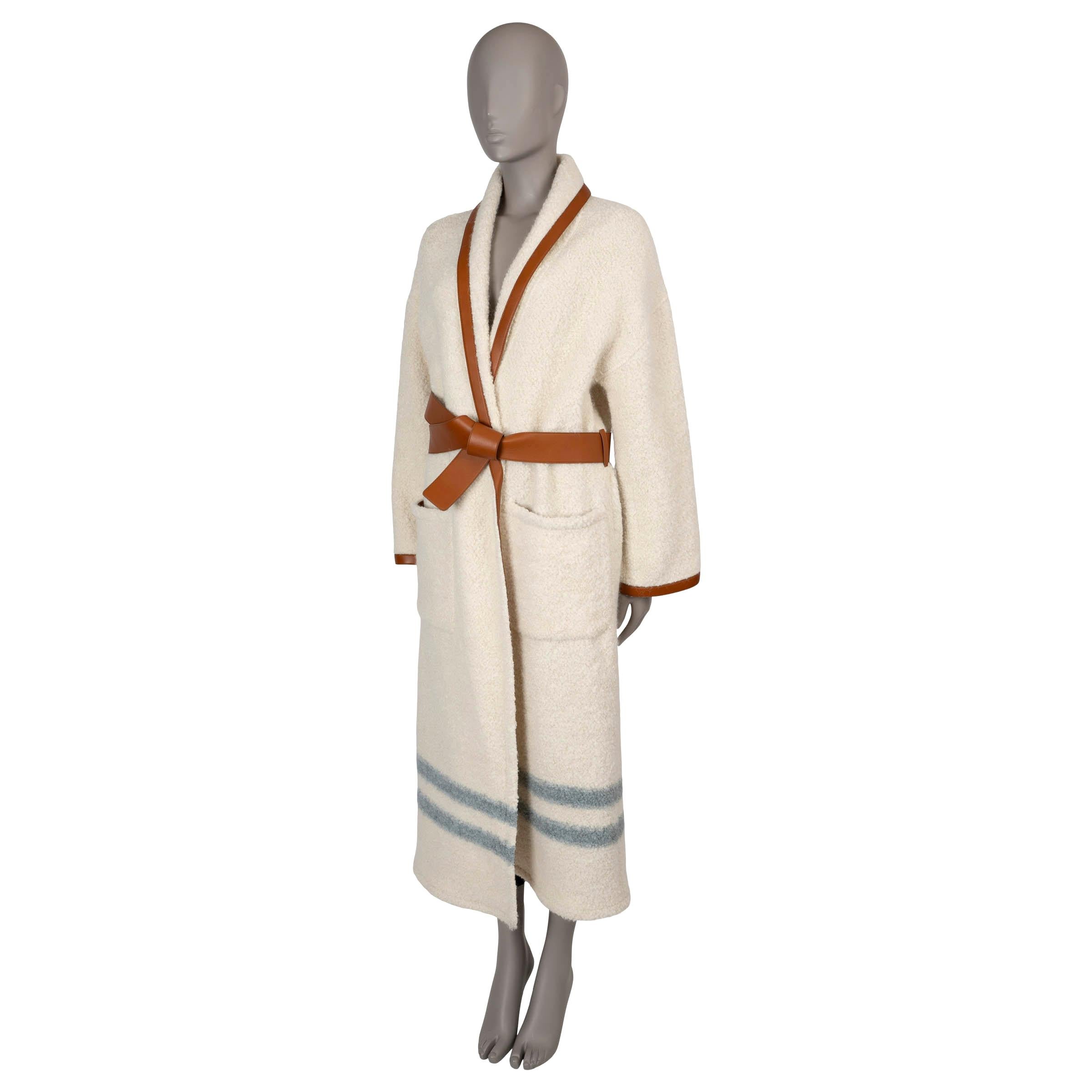 This 100% authentic Loro Piana Arbel knit coat in Nougat (cream) plush bouclé alpaca (70%), wool (19%), and polyamide (11%) offers luxurious warmth and texture. Featuring an oversized, midi-length silhouette with dropped shoulders, this coat is