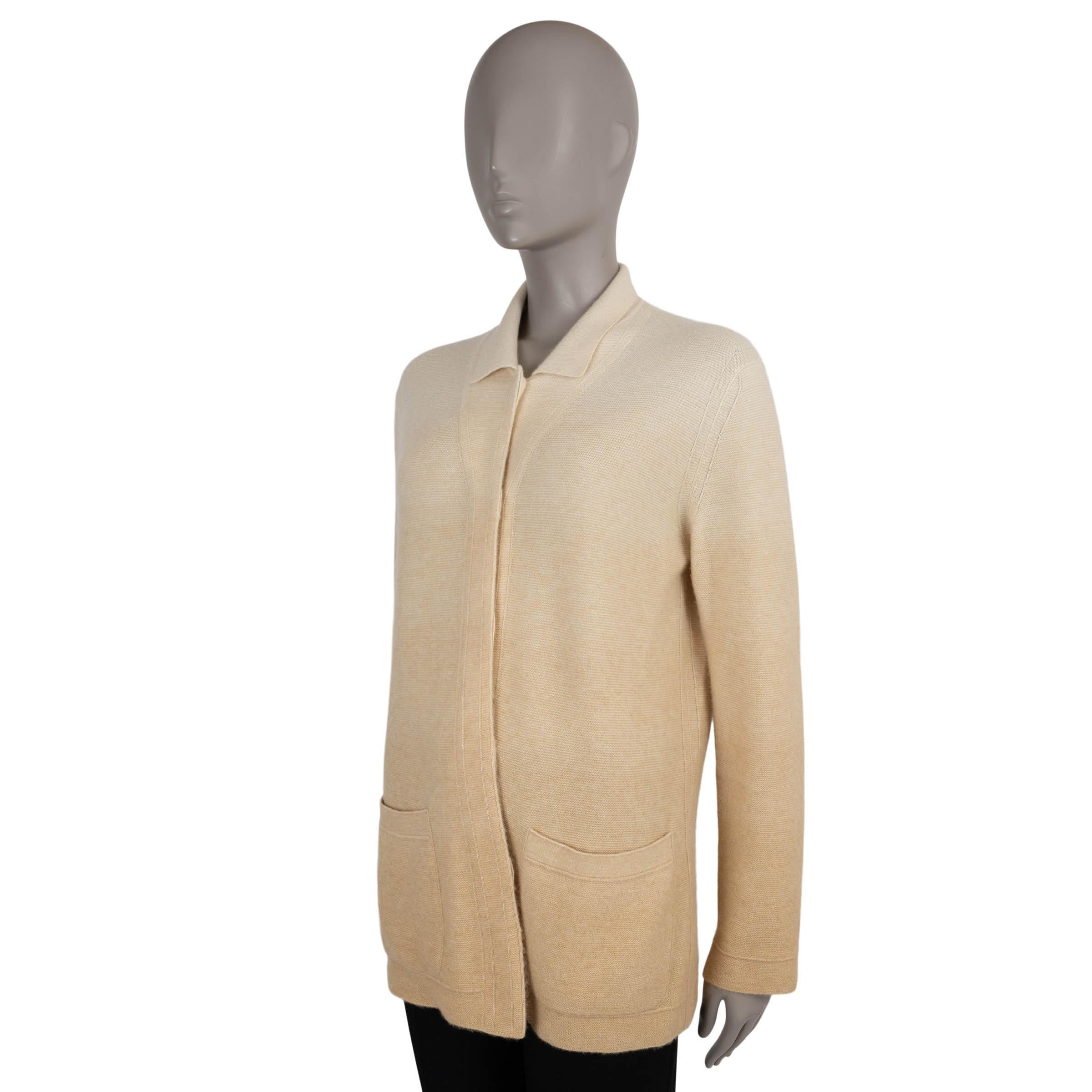This 100% authentic Loro Piana cardigan is crafted in a luxurious gradient double knit jersey blend of cashmere (60%) and silk (40%) that transitions from cream to beige. Designed with a long-cut, relaxed silhouette, it features a polo collar, two