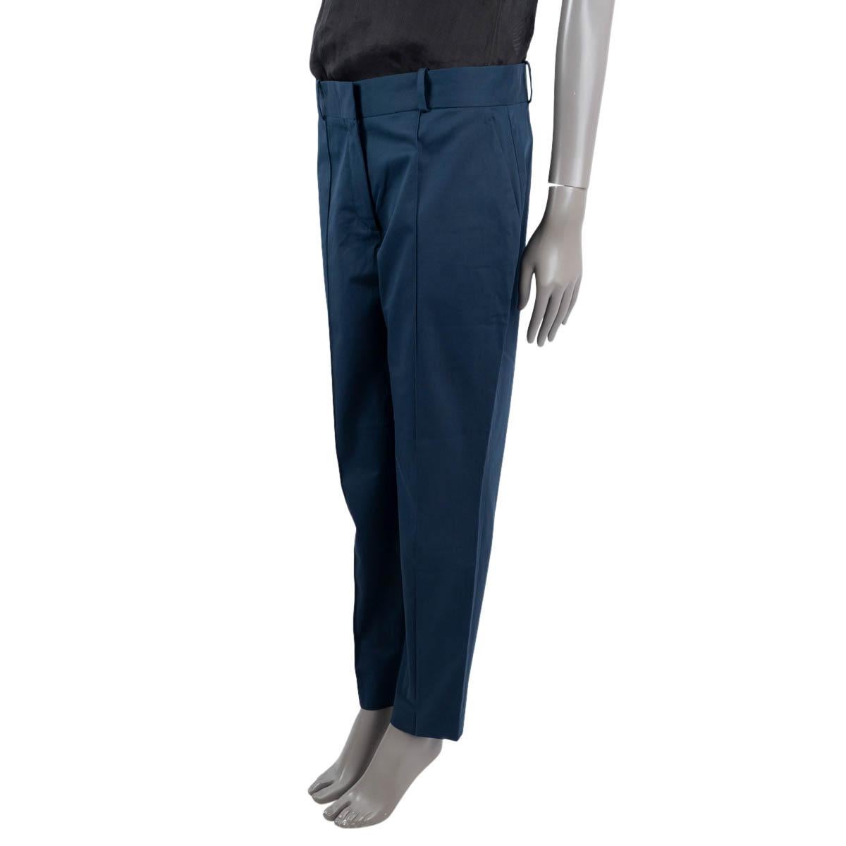 100% authentic Loro Piana tapered pants in dark blue cotton (96%) and elastane (4%) with belt loops. Features two pockets on the side, and two well-pockets on the back. Close on the front with a zipper and hook fasteners. Have been worn and are in