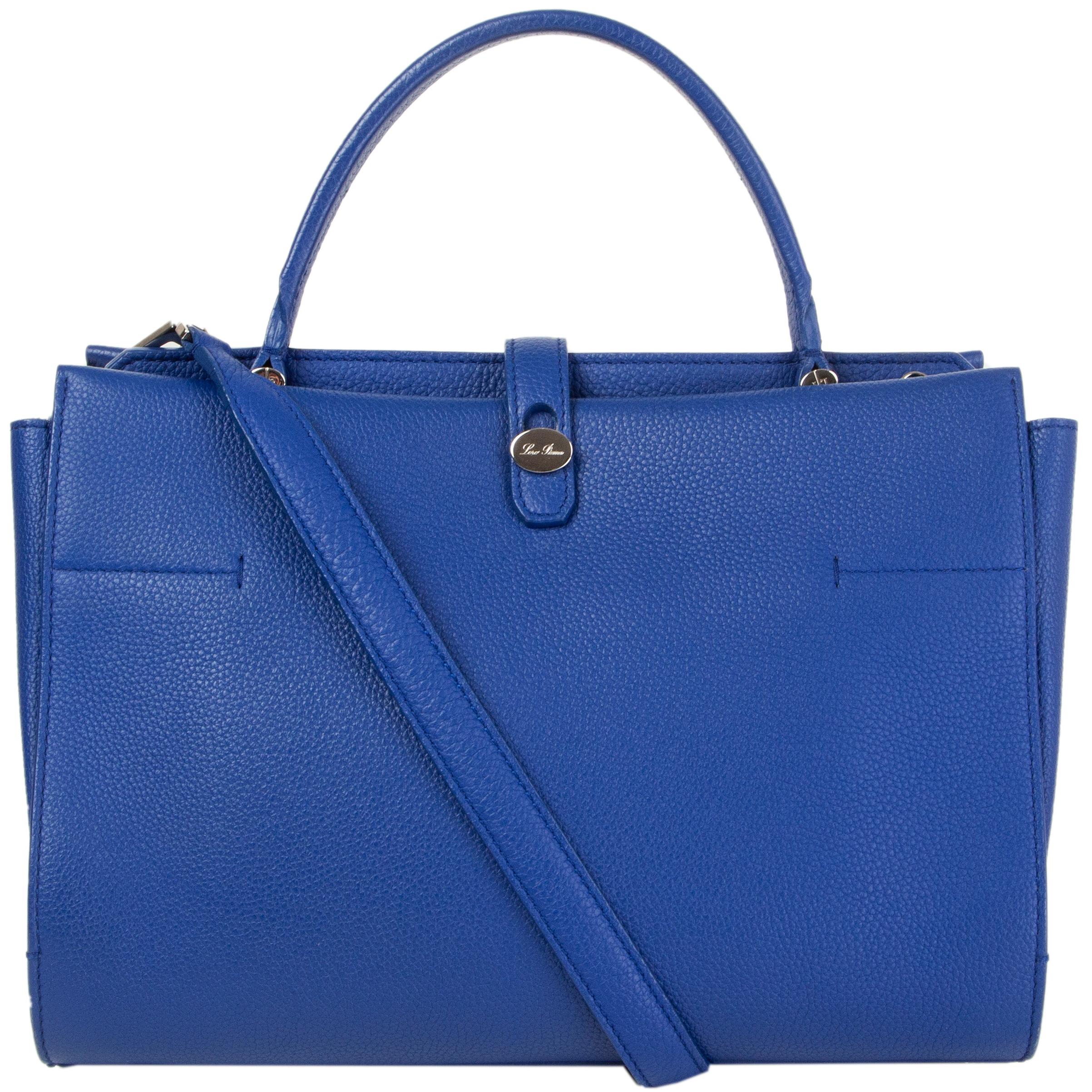 This 100% authentic Loro Piana 'Medium Cluisee G.Odessa' top-handle tote bag in electric blue grained calfskin featuring silver-tone hardware. Unlined with two roomy interior compartments with one zipper pocket against the back and two open pockets