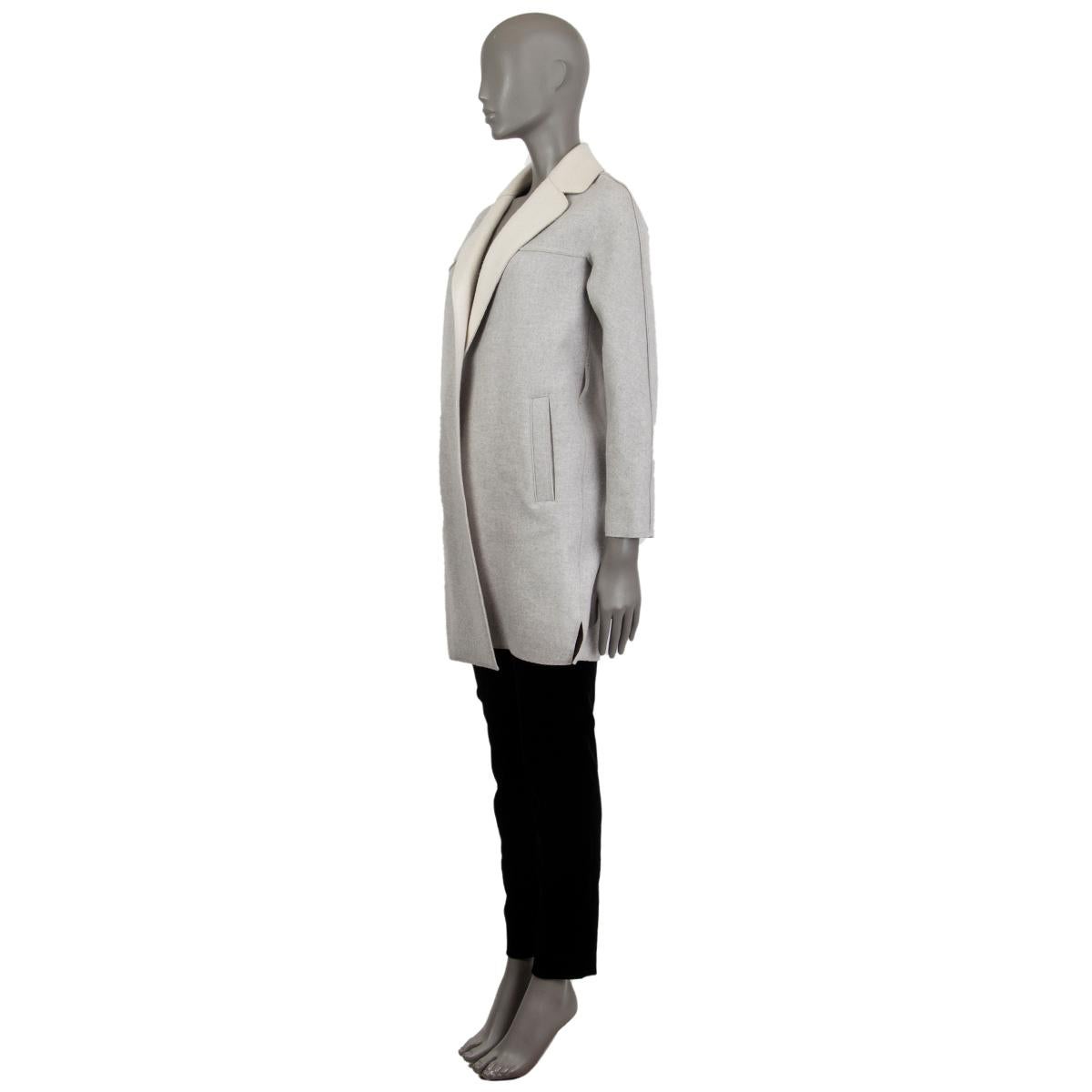 Loro Piana open coat in grey and beige cashmere (100%) with a notch collar and two front slit pockets. Unlined. Missing what was a probable matching belt, otherwise it in excellent condition. 

Tag Size 36
Size XXS
Shoulder Width 42cm (16.4in)
Bust