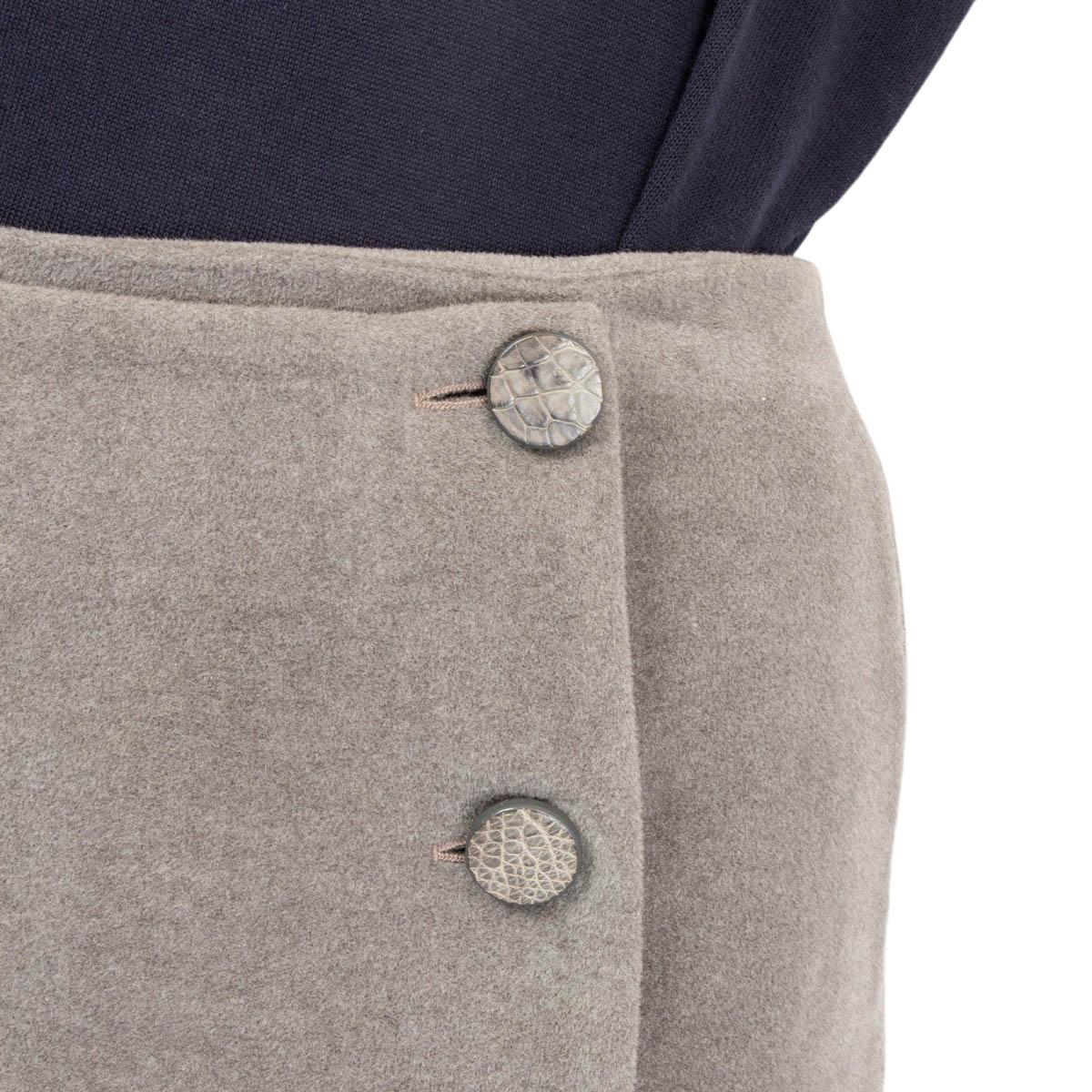 100% authentic Loro Piana wrap pencil skirt in gray cashmere (assumed cause tag is missing). Opens with six crocodile covered buttons on the front. Lined in silk (assumed cause tag is missing). Has been worn and is in excellent condition. Comes with