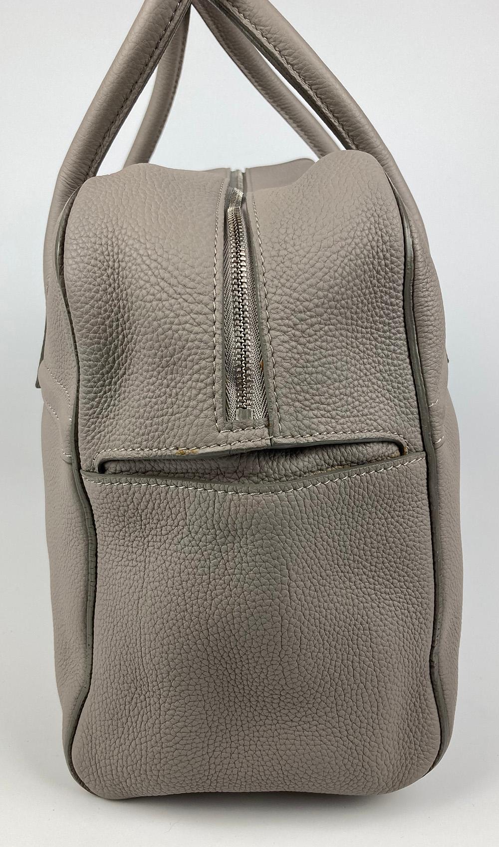 Loro Piana Grey Leather Duffle Tote in excellent condition. Grey leather lambskin exterior trimmed with top double handles, silver hardware and removable shoulder strap. Top zip closure opens to a grey leather interior with 3 slit side pockets, one