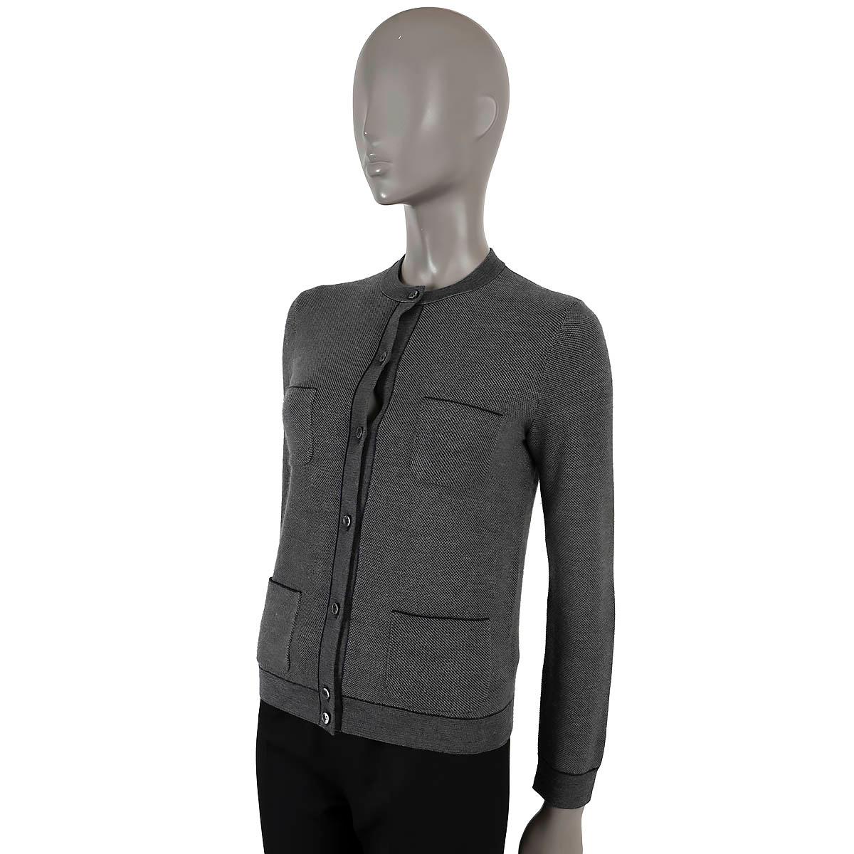 100% authentic Loro Piana cardigan in grey and navy blue silk (64%) and cashmere (36%). Features four patch pockets on the front and opens with buttons. Has been worn and is in excellent condition. 

Matching sweater vest and pants available in