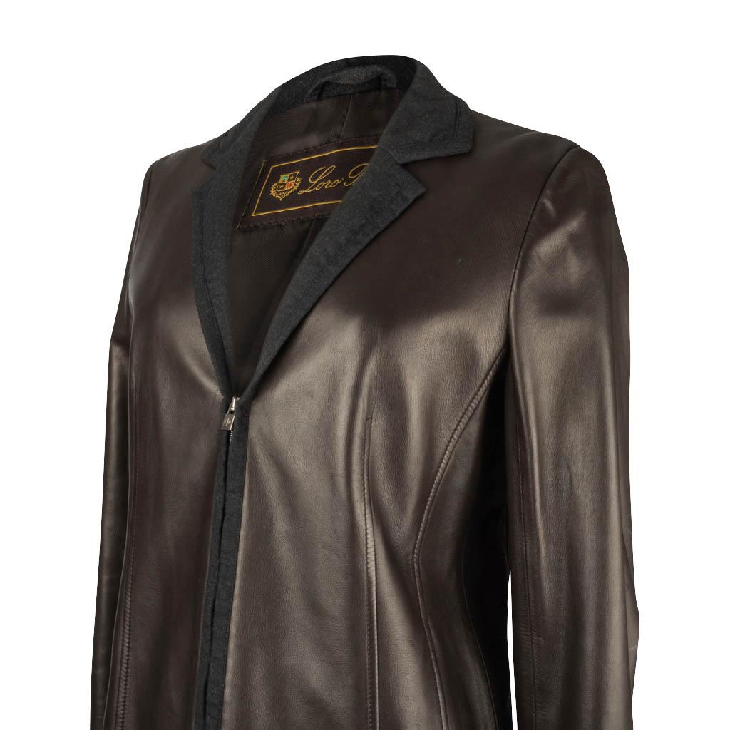 Guaranteed authentic Loro Piana very dark brown leather jacket features a zip front closure.
Jacket collar is grey cashmere. 
Zip and cuffs have the grey trim. 
Two hidden slot pockets. 
Fully lined. 
Sleeve has light markings.  See image 
final