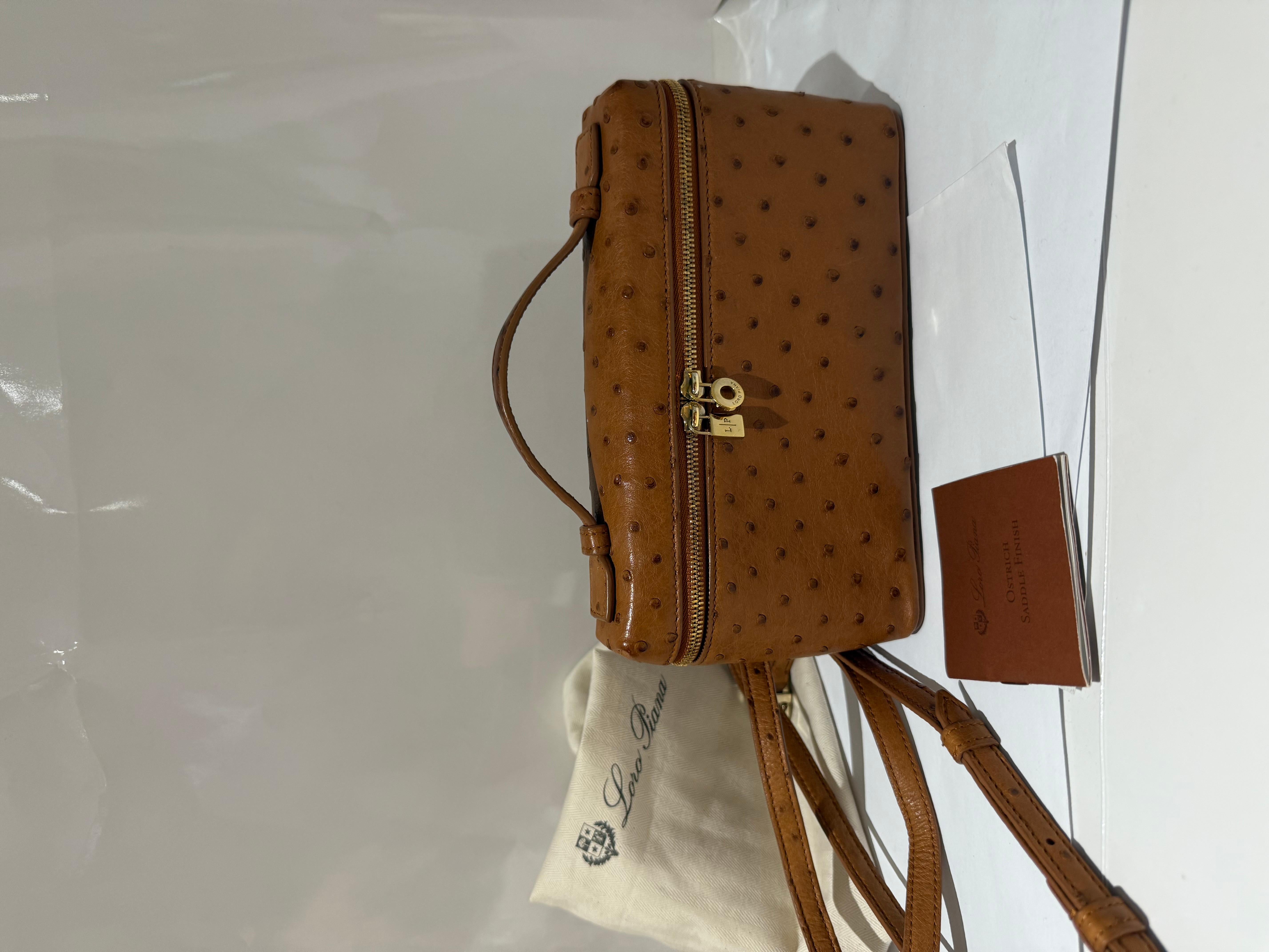Loro Piana LP 19 in ostrich tan colour clutch with gold hardware. Comes with dustbag, long strap and care letter. In very good condition. Few marks of being worn in the handle and corners. 