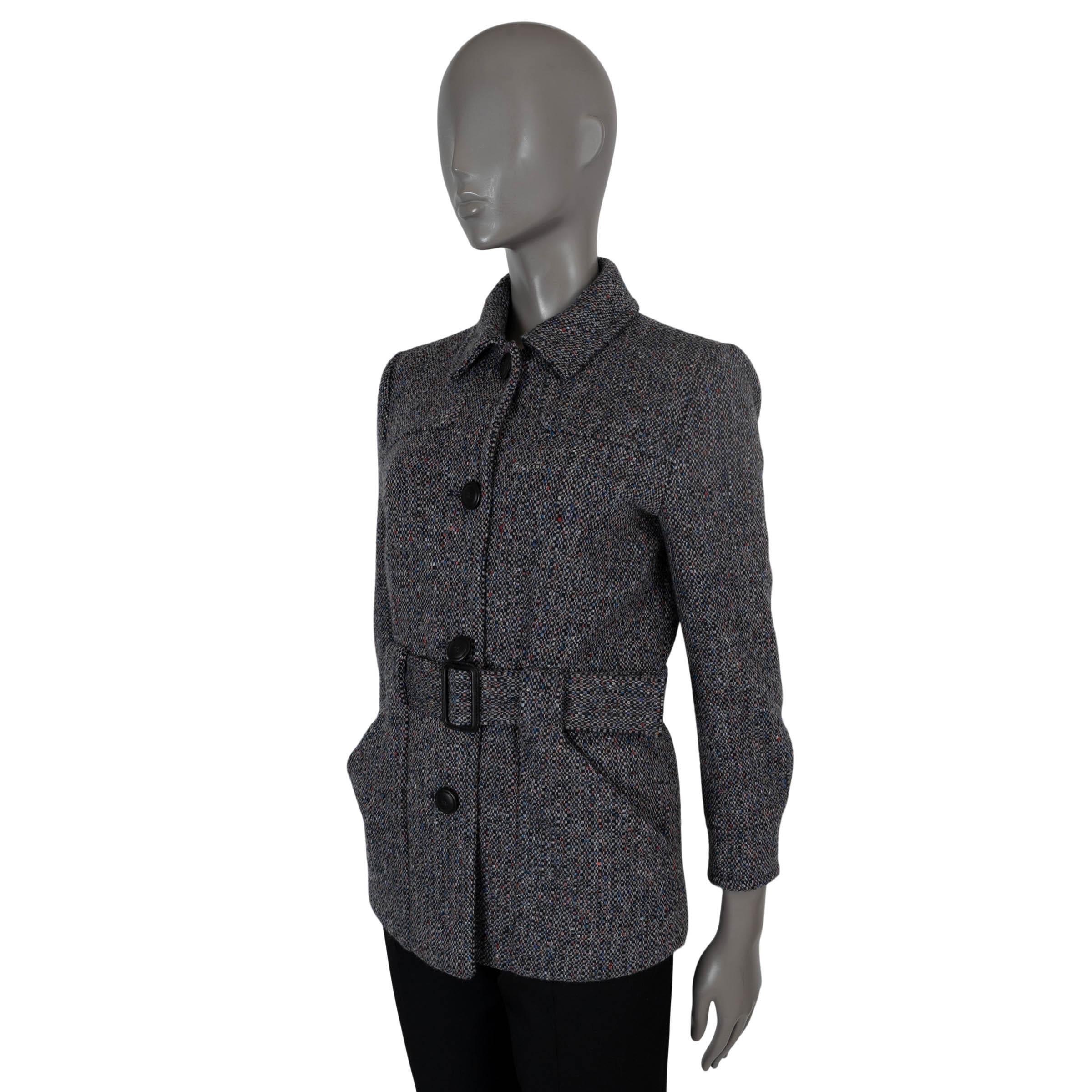 This 100% authentic Loro Piana Aran tweed jacket is crafted from luxurious black and cream cashmere with red, blue, and purple flecks, adding a subtle pop of color to the design. It features two slant pockets at the waist, integrated belt loops, and