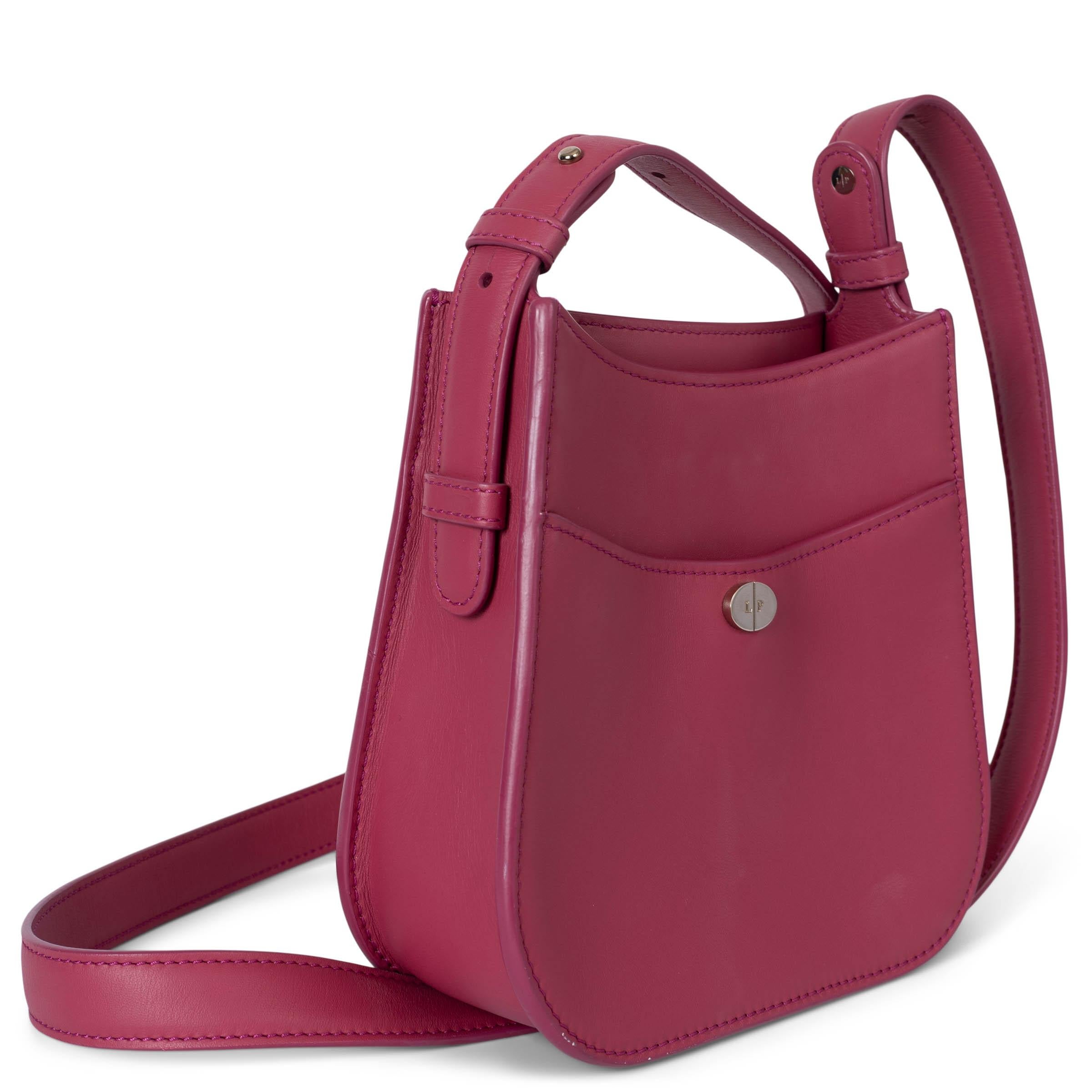 This 100% authentic crossbody bag is crafted from luxurious raspberry pink calfskin leather, offering both style and sophistication. It features an open top design, gold-tone hardware, a front snap pocket for easy access, and an inner zip pocket for