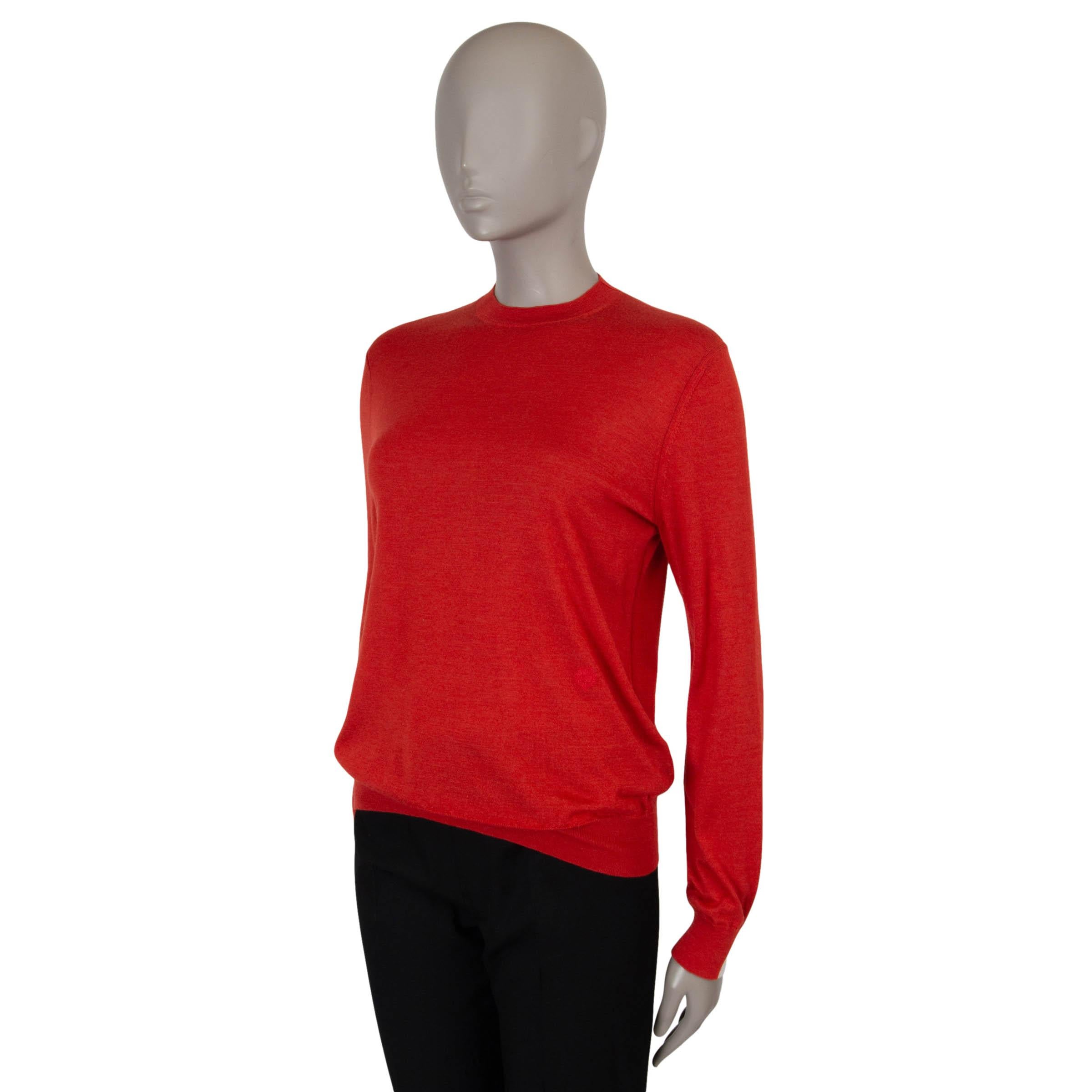 This 100% authentic Loro Piana sweater in red fine knit cashmere (70%) and silk (30%) offers a refined take on everyday luxury. Featuring a classic fit with a crewneck, rib-knit trims, and split cuffs revealing a second cream layer, it’s a