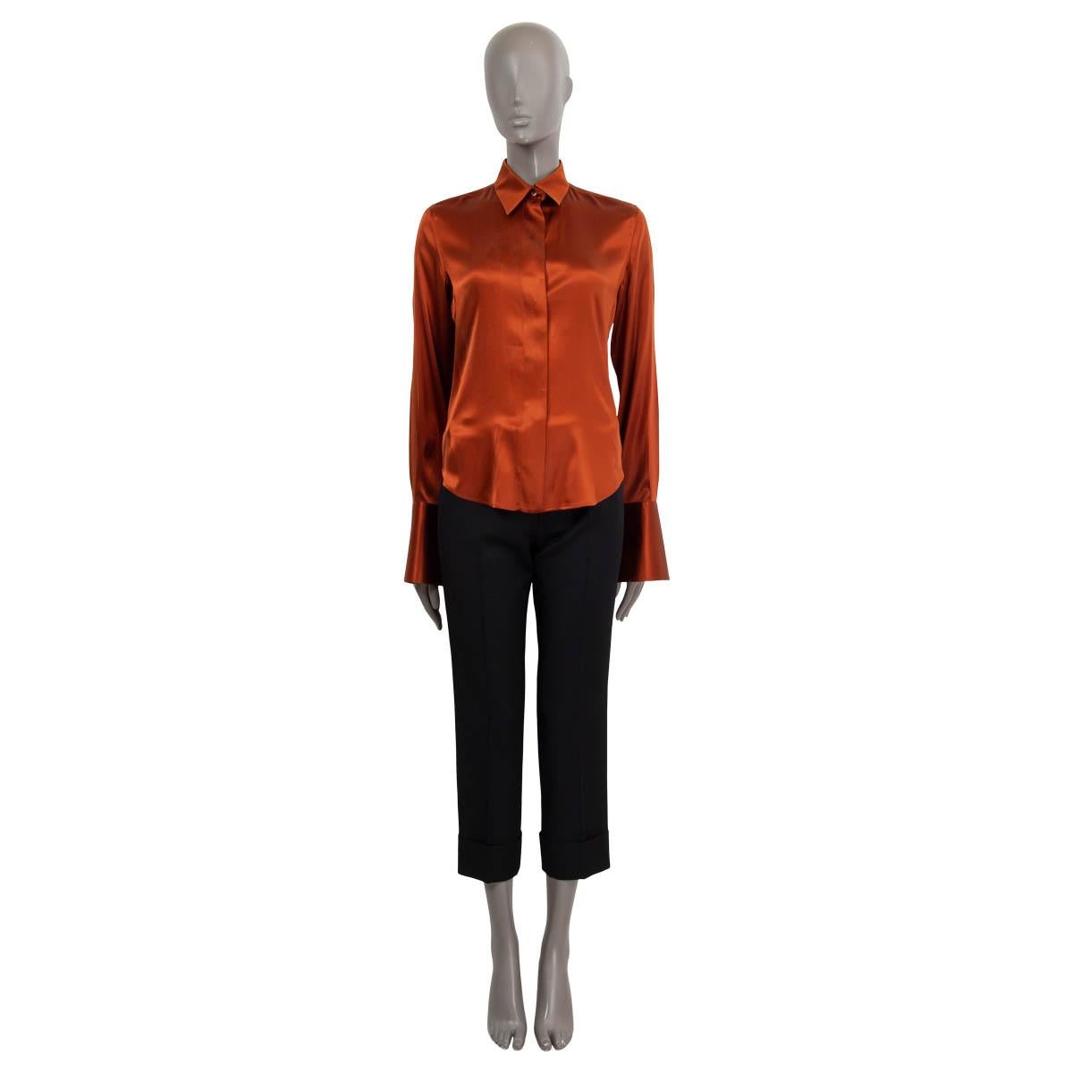 100% authentic Loro Piana long sleeve blouse in rust silk (100%) with a flat collar. Closes on the front with buttons. Unlined. Has cufflink holes - cuff links not included. Has been worn with a small scartch in the satin. Overall in excellent