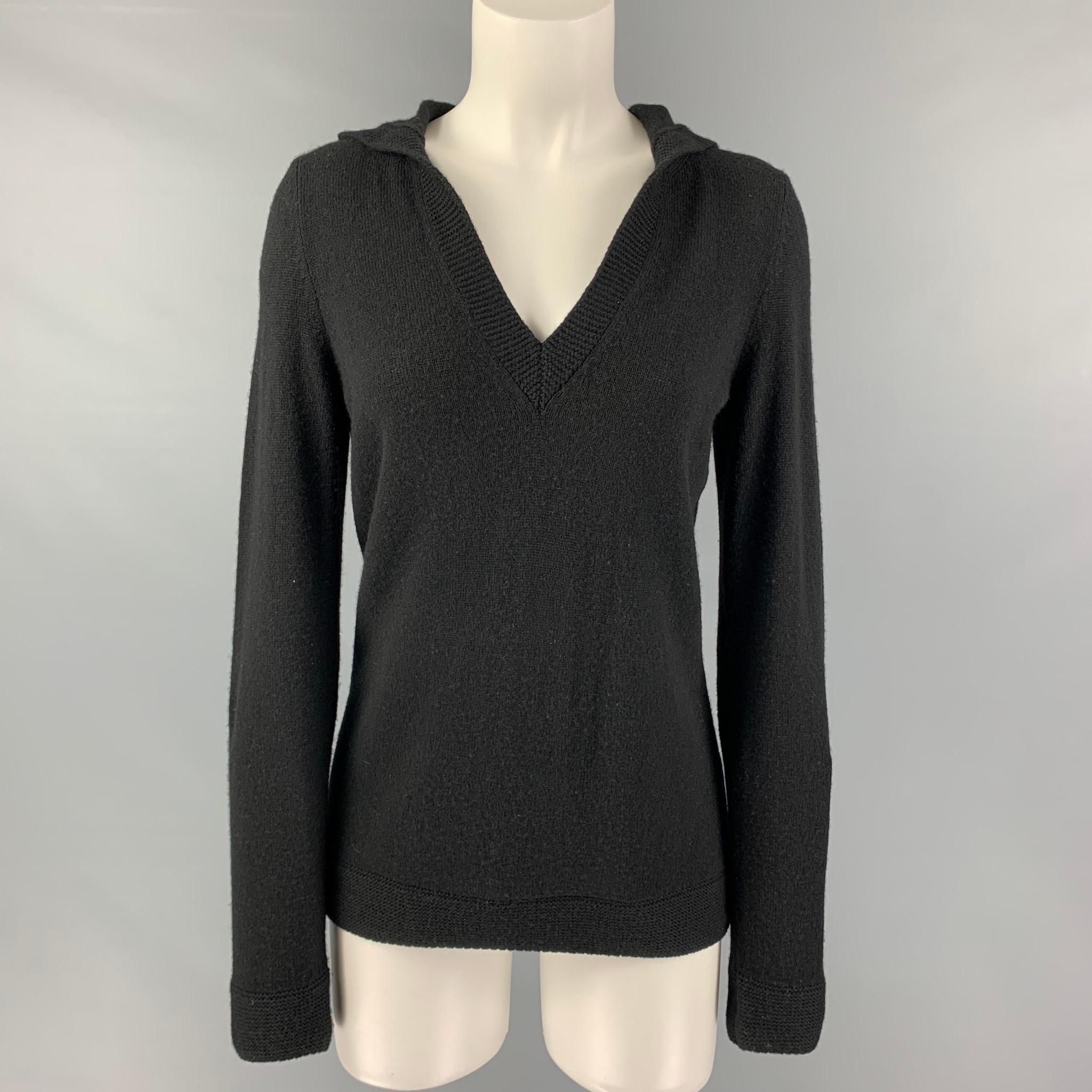 LORO PIANA sweater comes in a black cashmere featuring a hooded style, elbow patch, and a v-neck.

Good Pre-Owned Condition. Moderate Signs of Wear. As is.
Marked: 44

Measurements:

Shoulder: 14 in.
Bust: 42 in.
Sleeve: 27 in.
Length: 26.5