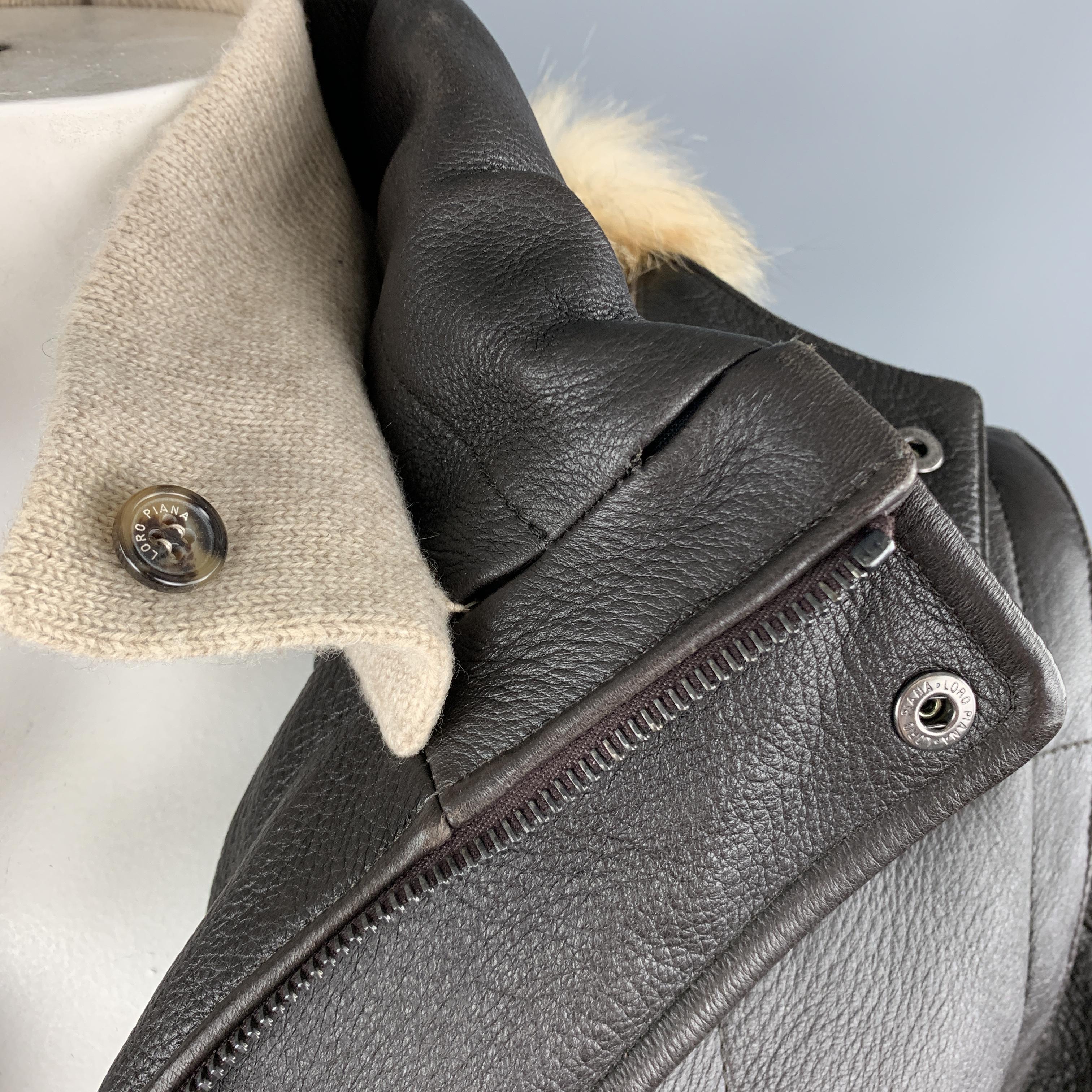 LORO PIANA parka jacket comes in brown quilted textured leather with a high neck with detachable cashmere liner, double zip up front with snap placket, cashmere lining, detachable hood with soft fox fur trim, and zip off sleeves. Made in Italy.

New