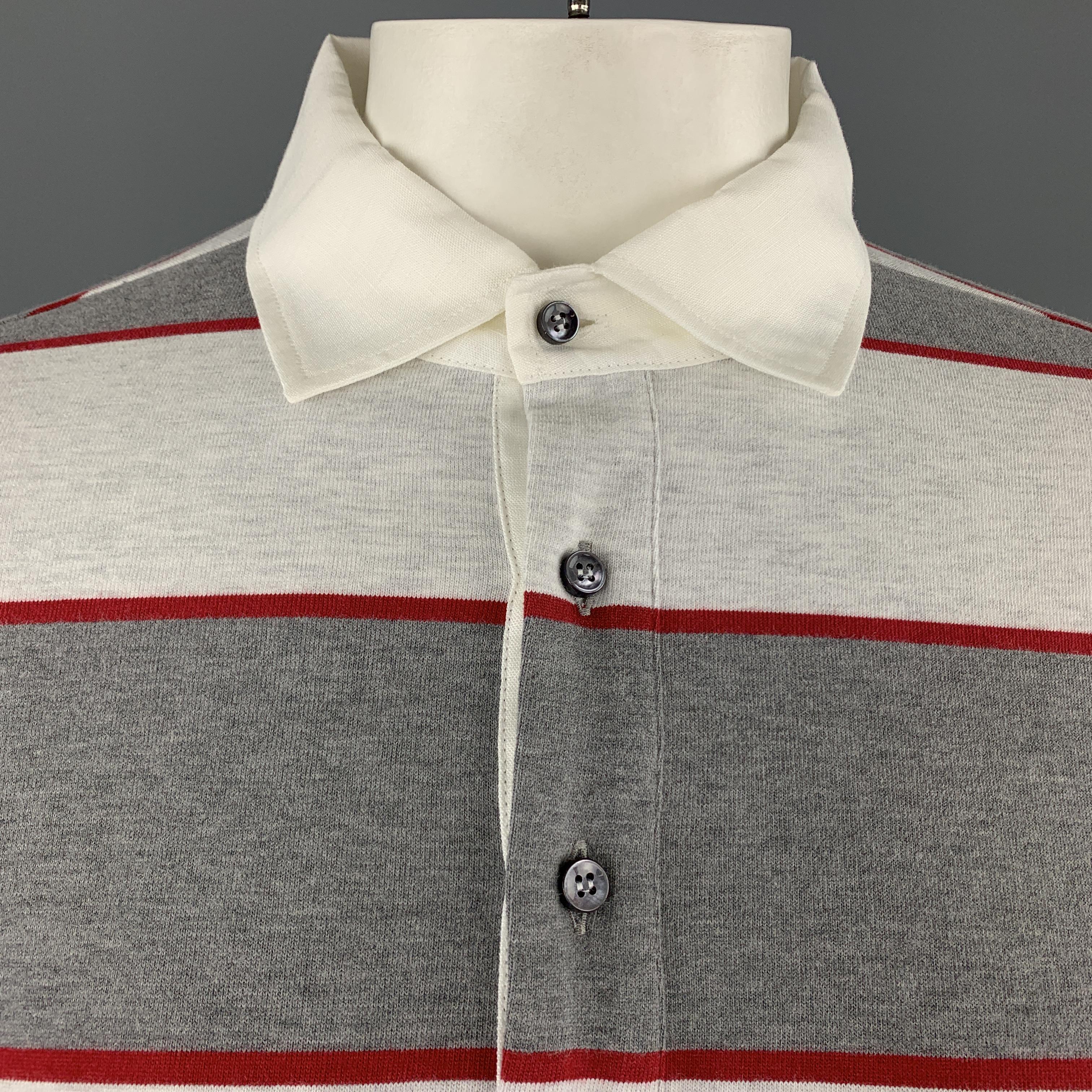 BRUNELLO CUCINELLI ruby polo comes in gray and red striped jersey with a white half button up collar. Made in Italy.

New with Tags.
Marked: XL

Measurements:

Shoulder: 18 in.
Chest: 46 in.
Sleeve: 27 in.
Length: 29 in.