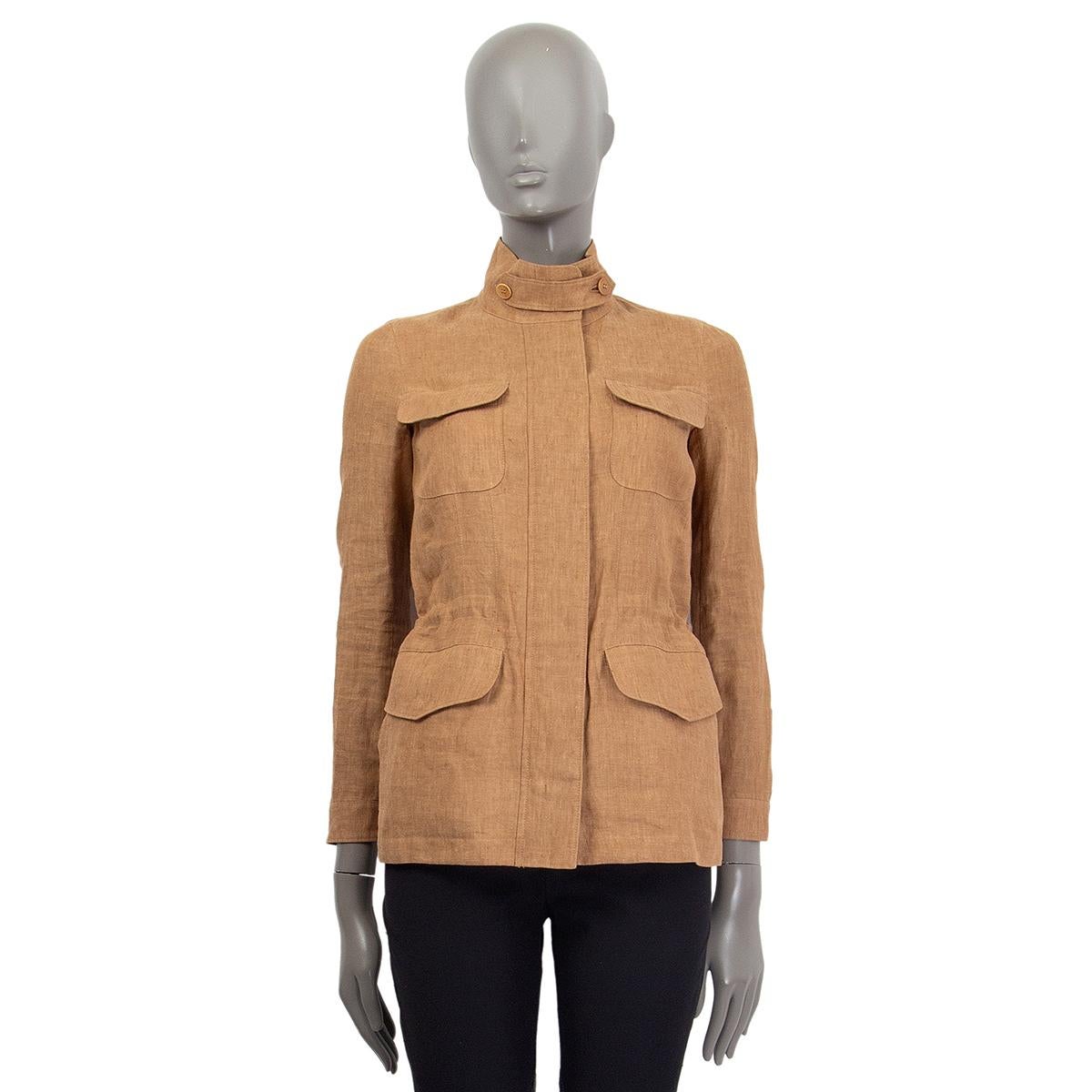 Loro Piana safari jacket from mens collection in tan linen/flax (100%) with a high collar, multi-purpose pockets and a waist drawstring. Closes on the front with a gold tone zipper and gold tone snap buttons. Cuffs close with gold tone snap buttons.