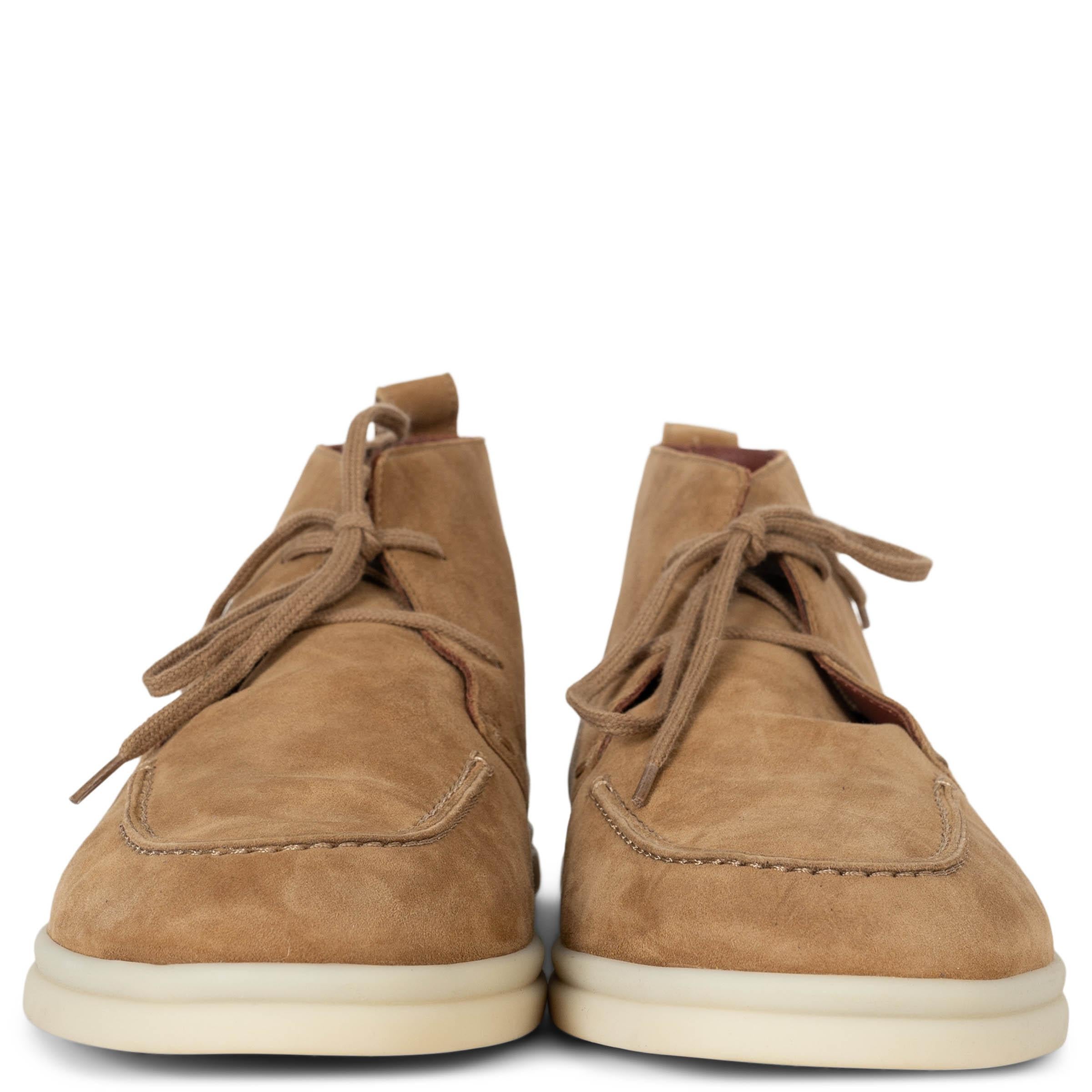 This 100% authentic Loro Piana Namib dessert ankle boots in tan water-repellent suede blend timeless craftsmanship with functional elegance. Featuring round toes, hand-stitched detailing on the front upper, and white rubber soles, they offer both