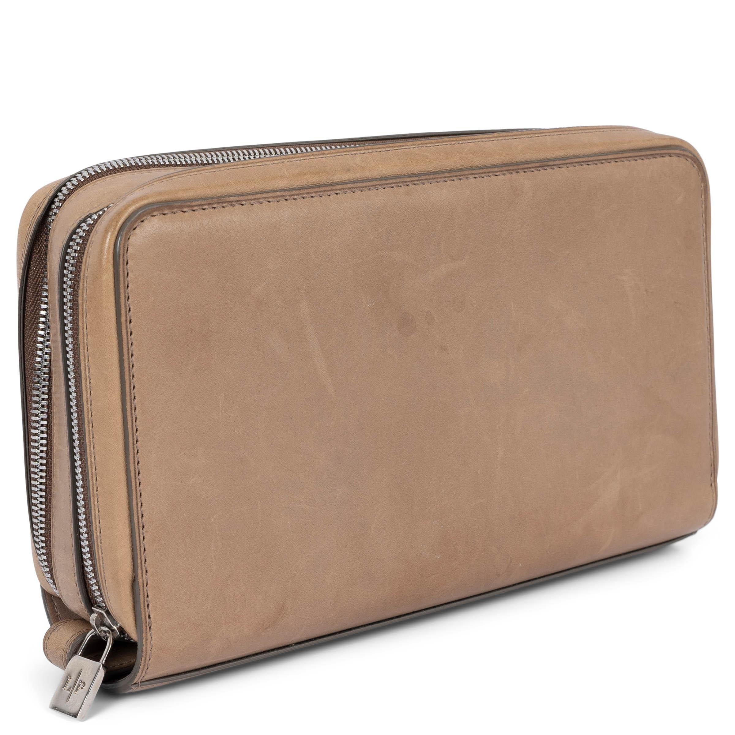 100% authentic Loro Piana zip-around continental wallet in taupe smooth leather. Opens with a two zippers on top and is lined in taupe leather with several credit card slots, bill and notes compartments and two zipped coin pockets. Has been carried