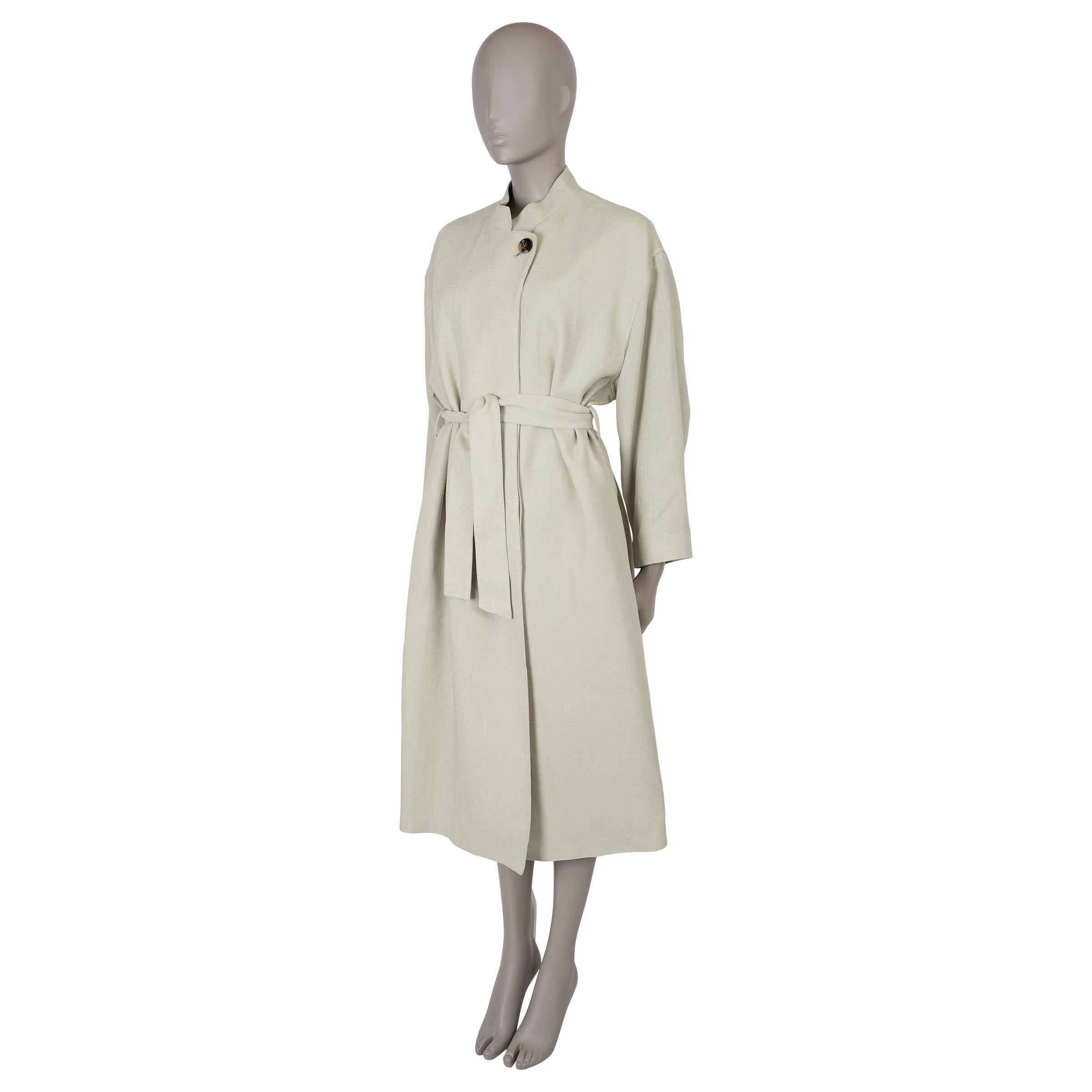 This 100% authentic Loro Piana Edvin coat in Wild Sage (pale green) linen offers a relaxed, effortlessly chic silhouette with dropped shoulders and a midi length. It features a refined band collar, two slant pockets, and closes with horn buttons—one