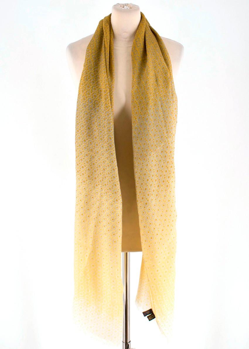 Loro Piana mustard printed scarf with frayed ends. Woven from a lightweight cashmere and silk-blend.  The large square silhouette ensures you can comfortably wrap it around the neck several times.  RRP £755

Please note, these items are pre-owned