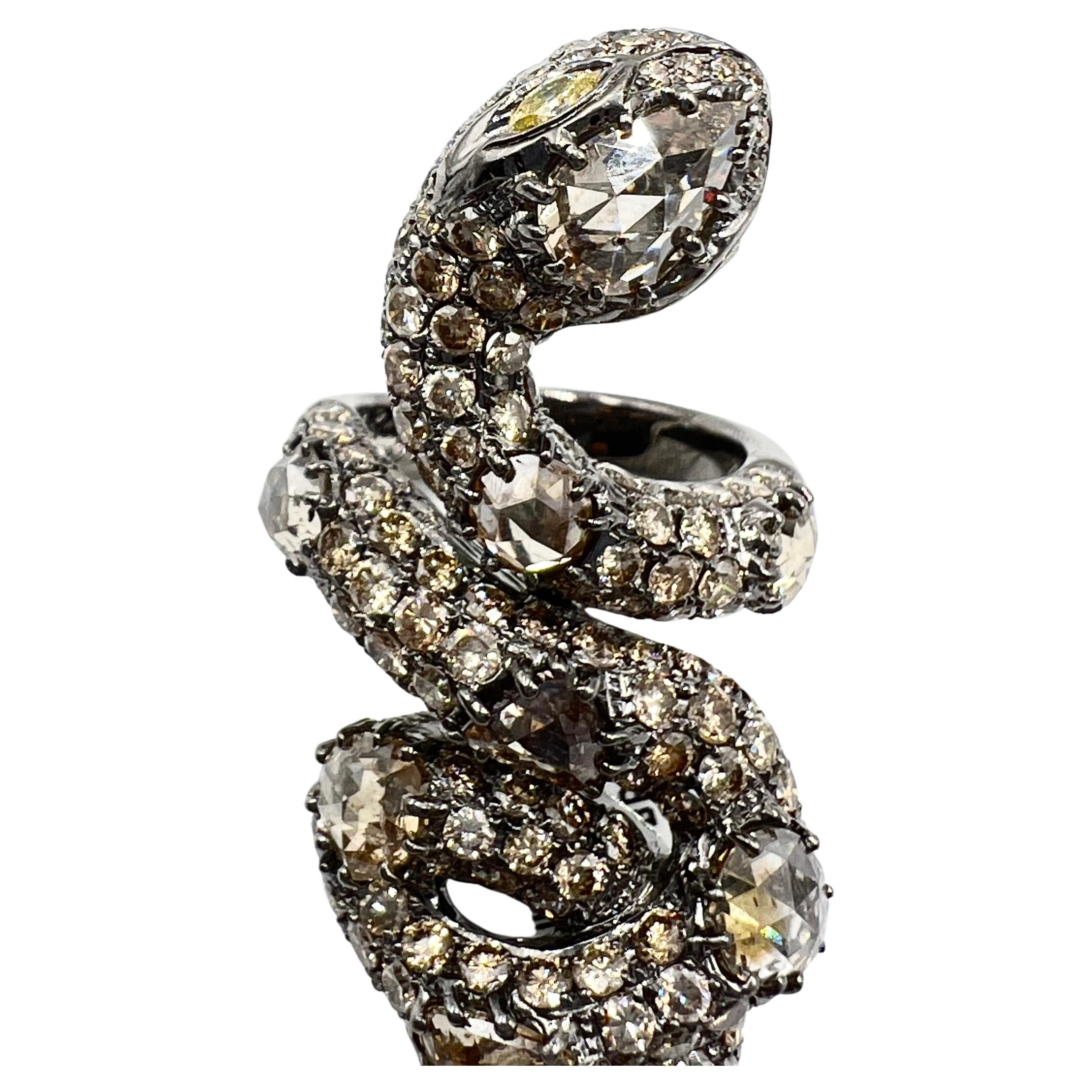 Lorraine Schwartz snake wrap ring accented by rose-cut champagne-colored natural diamonds throughout in blackened 18k gold. The serpent design is partially coiled and wraps up the finger measuring approximate L.2 1/4